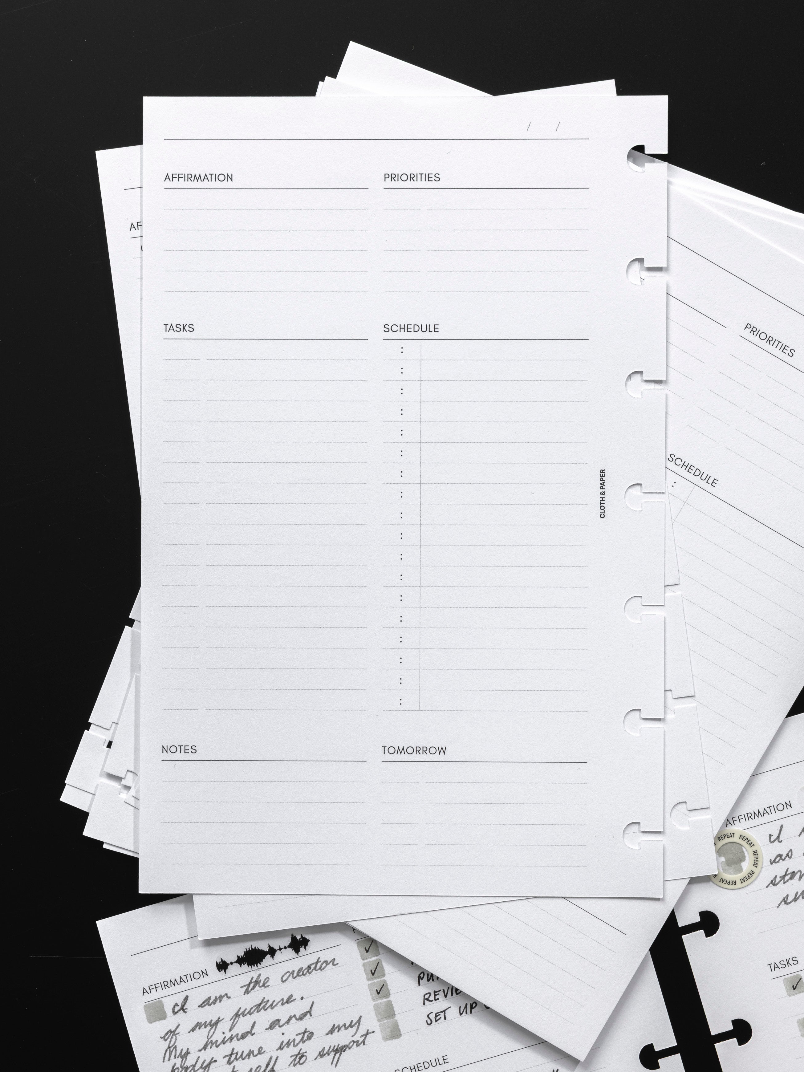 Daily Essentials Planner Inserts shown against a black background.