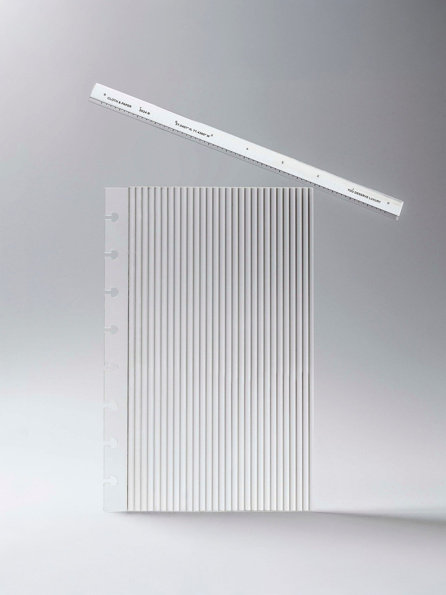 Dashboard displayed on a neutral background. An Acrylic Straight Edge Ruler is displayed balanced on top of it.