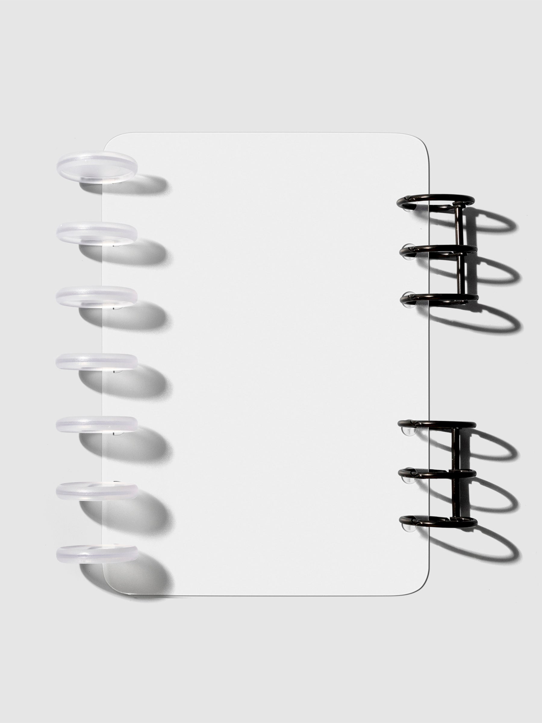 HP Mini / Personal cover displayed on a neutral background. It is shown filled with a set of clear planner discs and black planner rings.