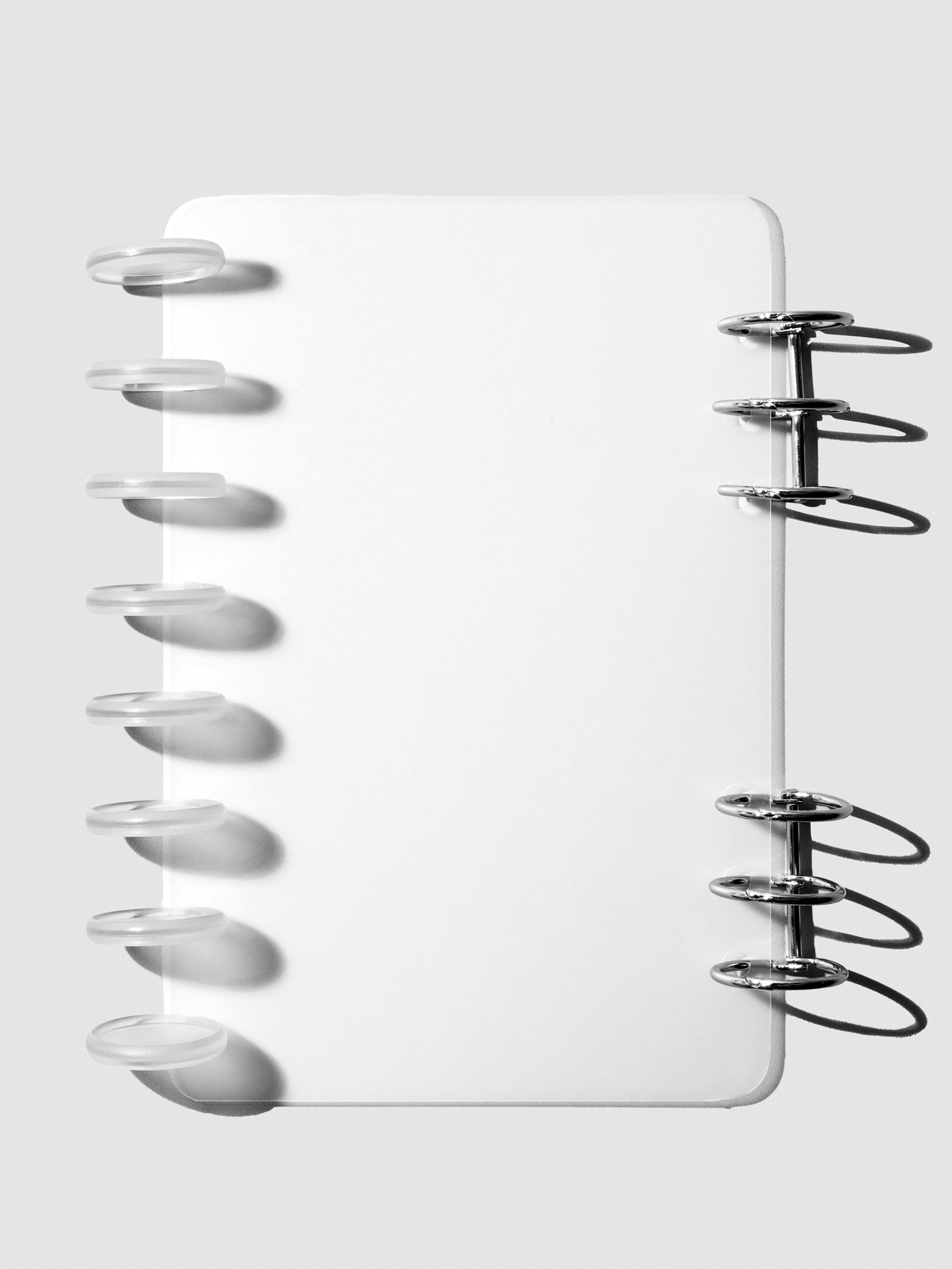 Half Letter/A5-Ring cover displayed on a neutral background. It is shown filled with a set of clear planner discs and black planner rings.