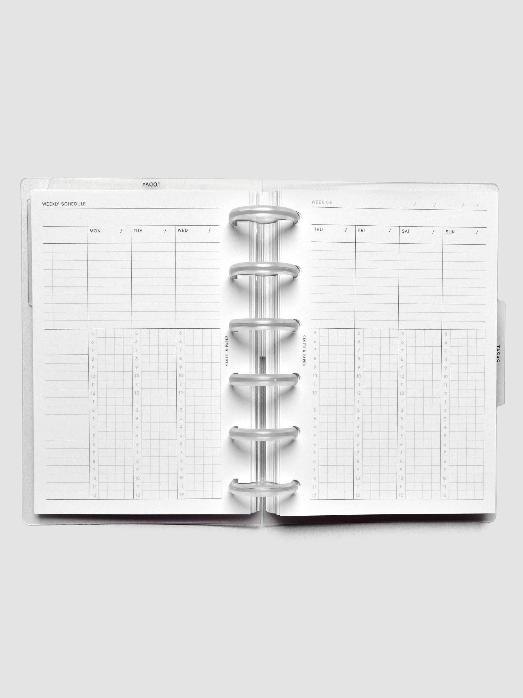 Open discbound planner displaying a vertical weekly schedule layout.
