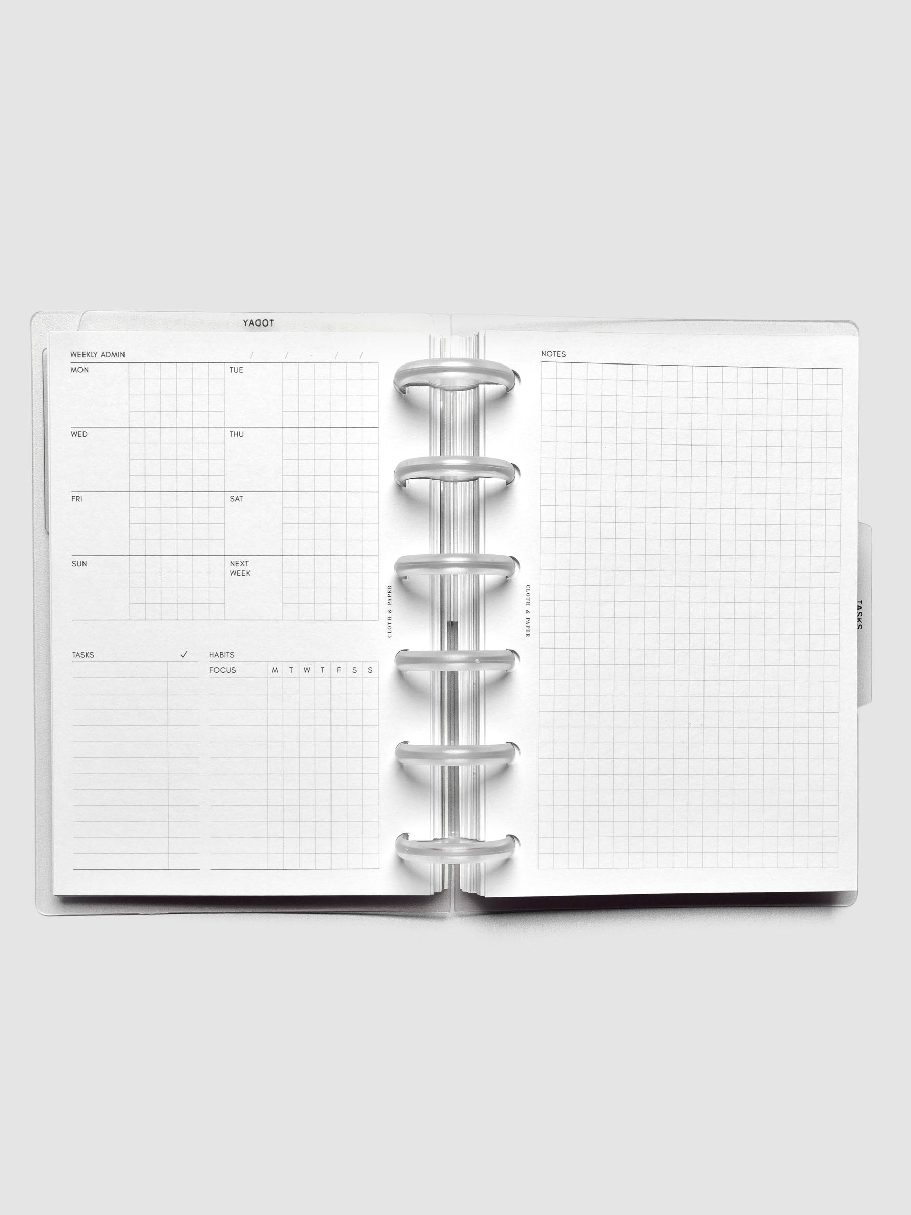 Open discbound planner showing a undated monday start weekly admin page on the left and a graph notes page on the right.