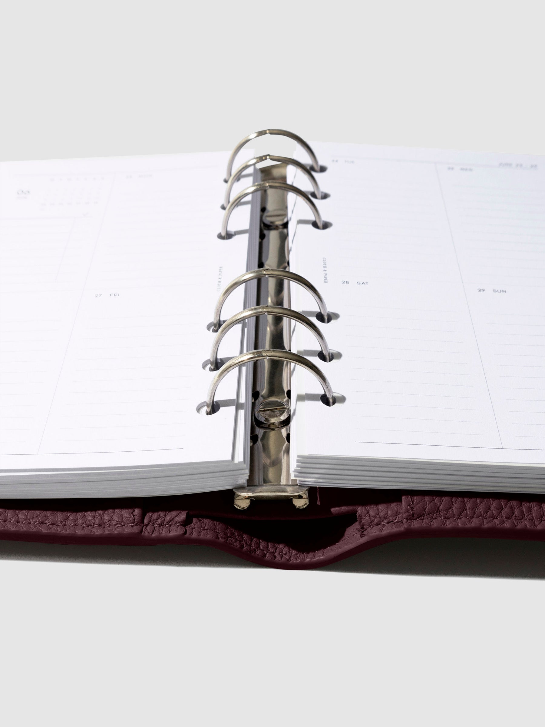 Close-up of the dark burgundy leather agenda ring mechanism.