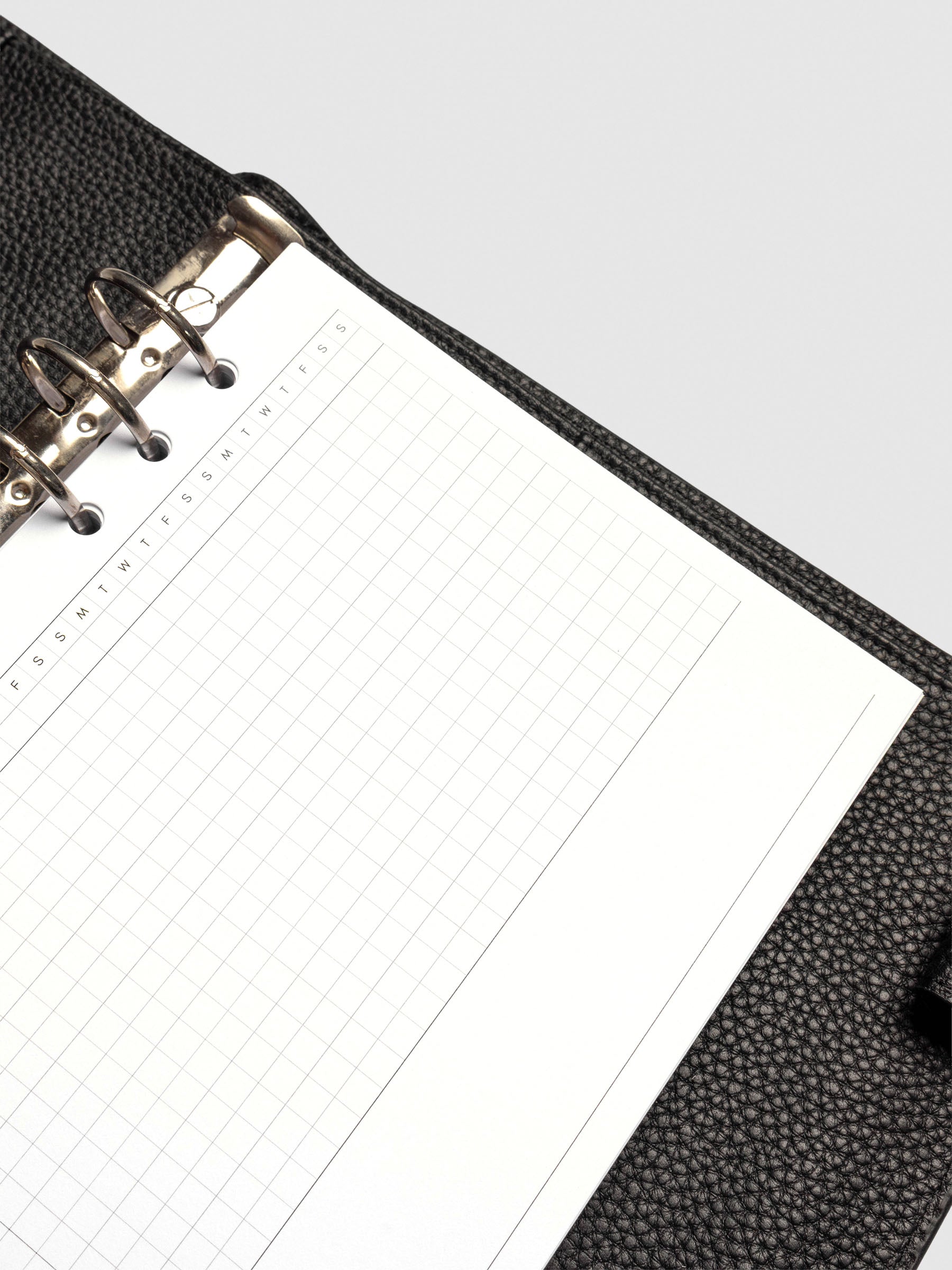 Close up of GanttChart inserts inside discbound planner and leather cover.