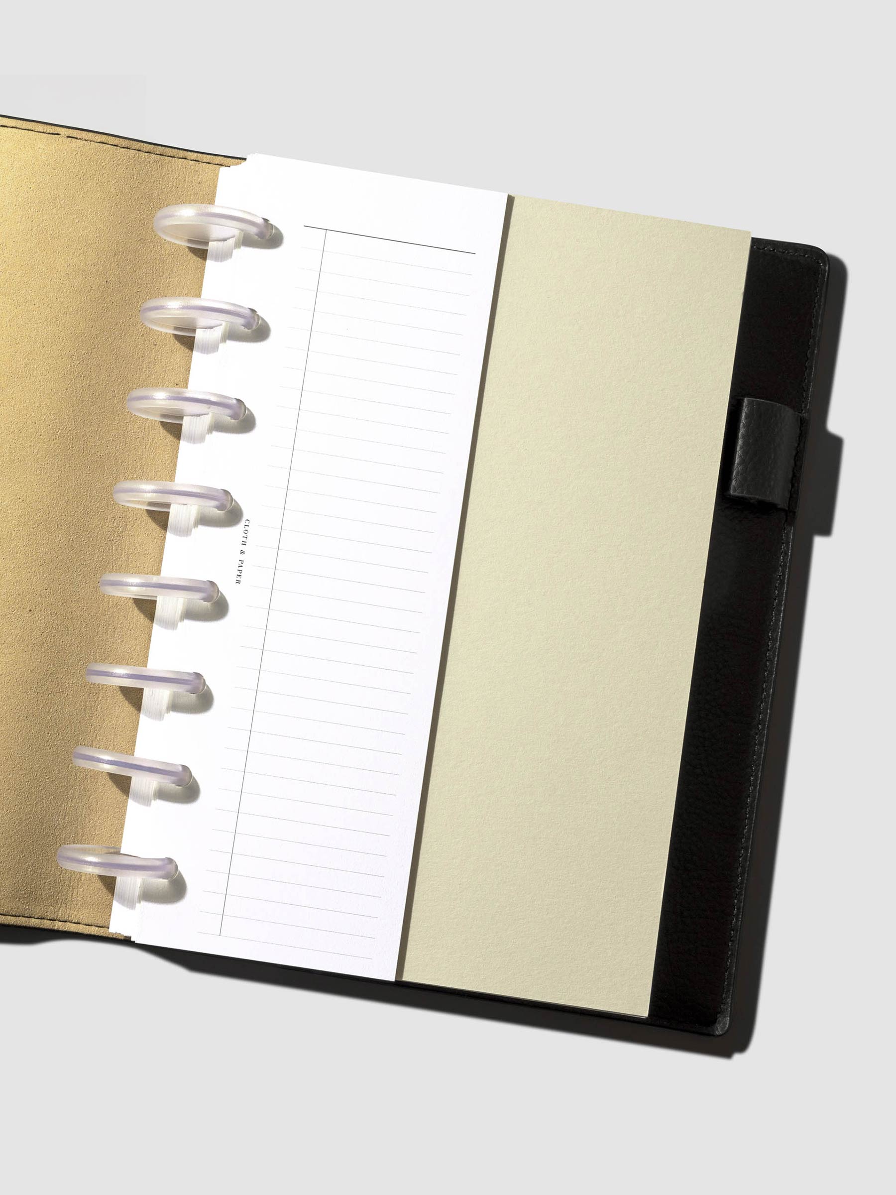 Insert displayed inside a leather planner.