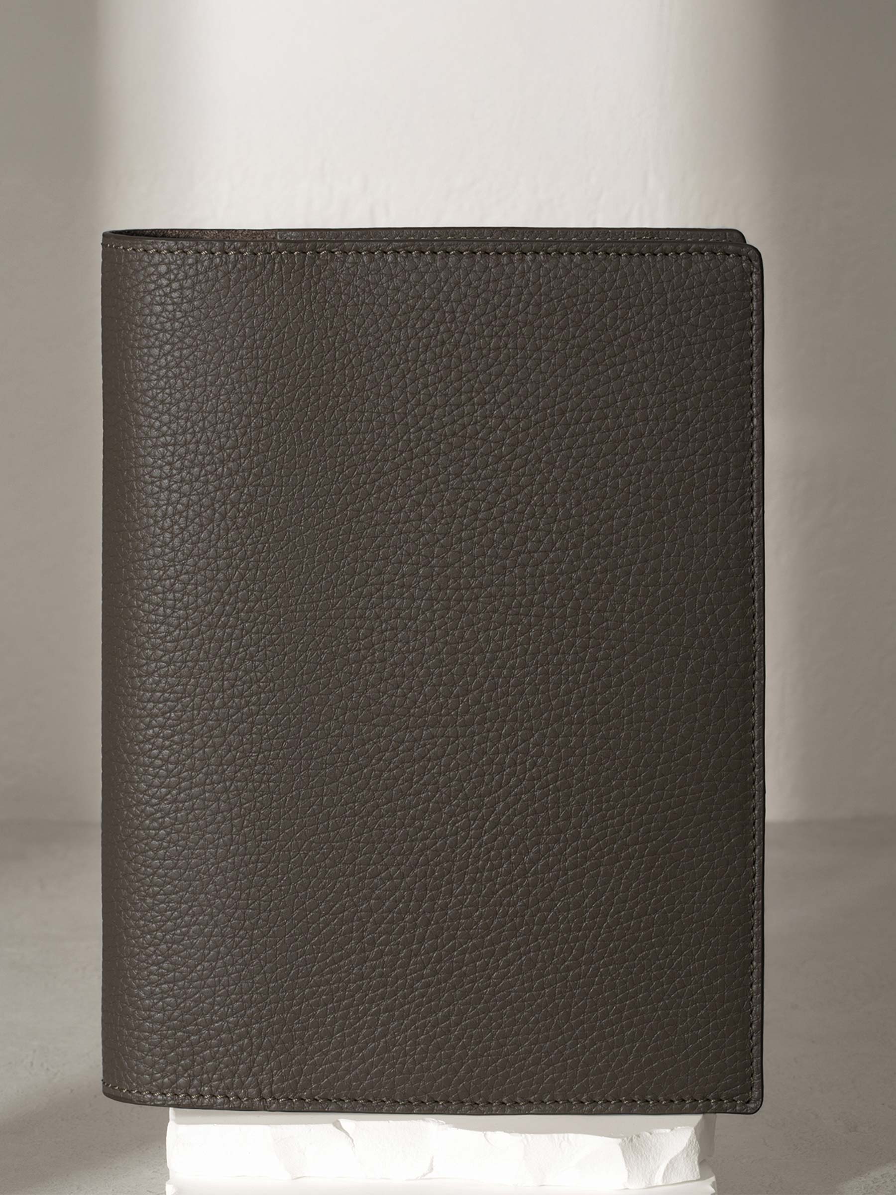 Leon folio displayed on a white pedestal.