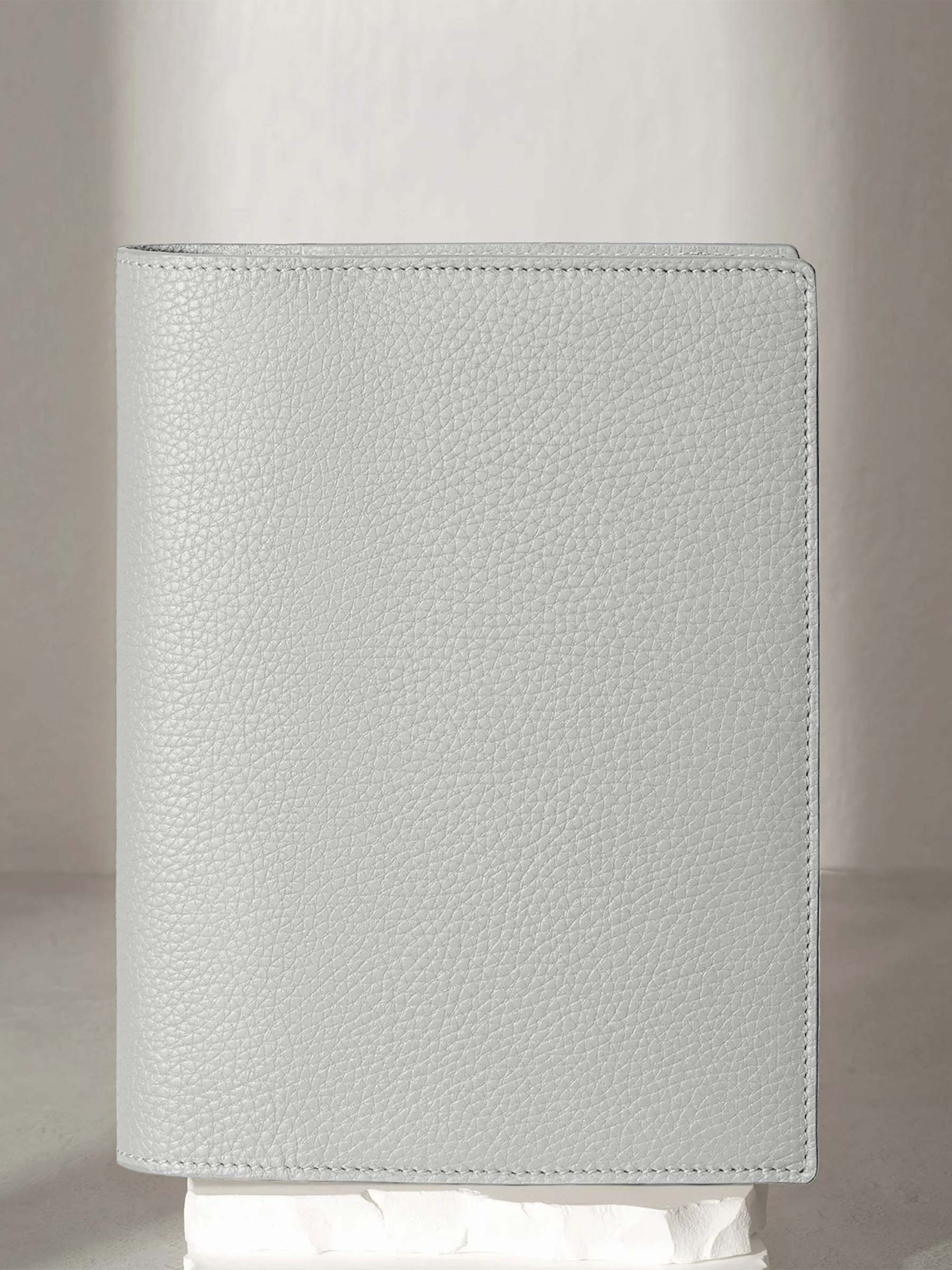 Veleta folio displayed on a white pedestal.