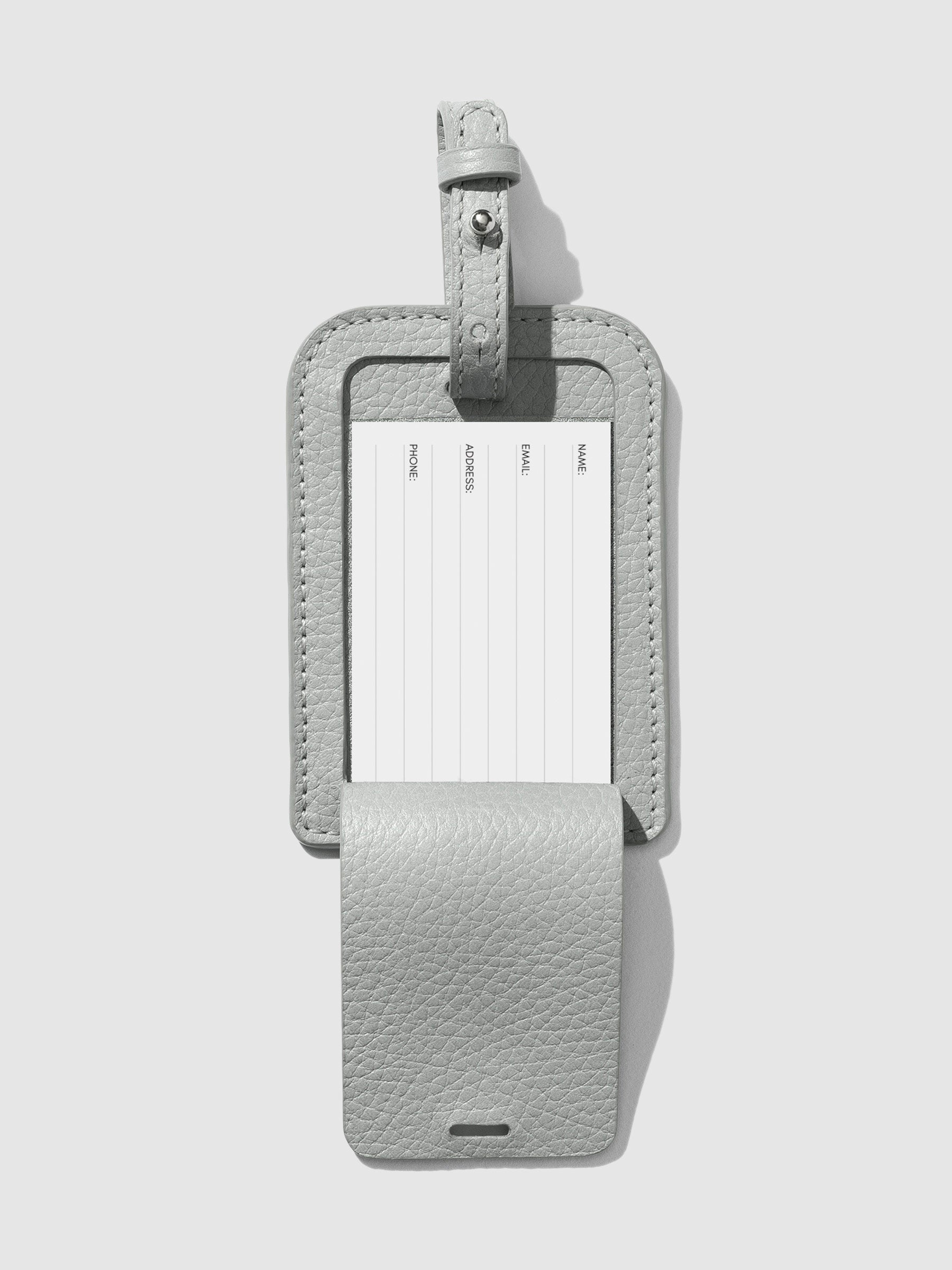 Heirloom Luggage Tag - Veleta in a neutral background revealing essential travel information: neatly inscribed name, email, address, and phone number on a crisp paper insert.