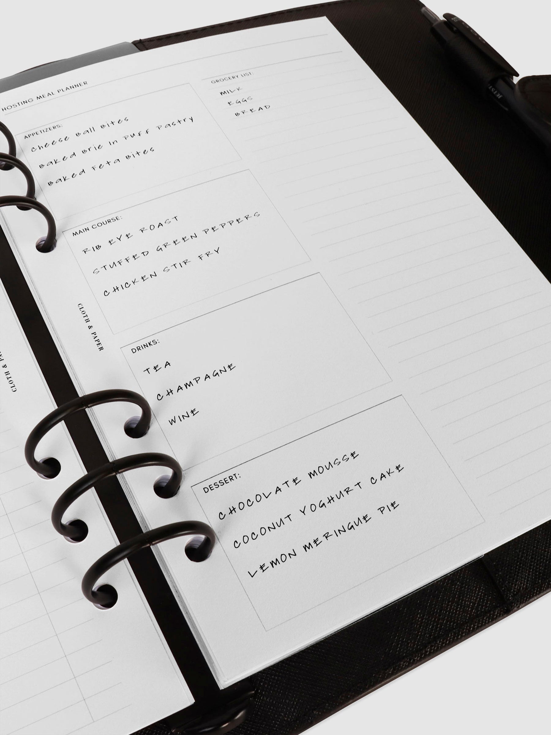 Inserts in use inside a black leather agenda.