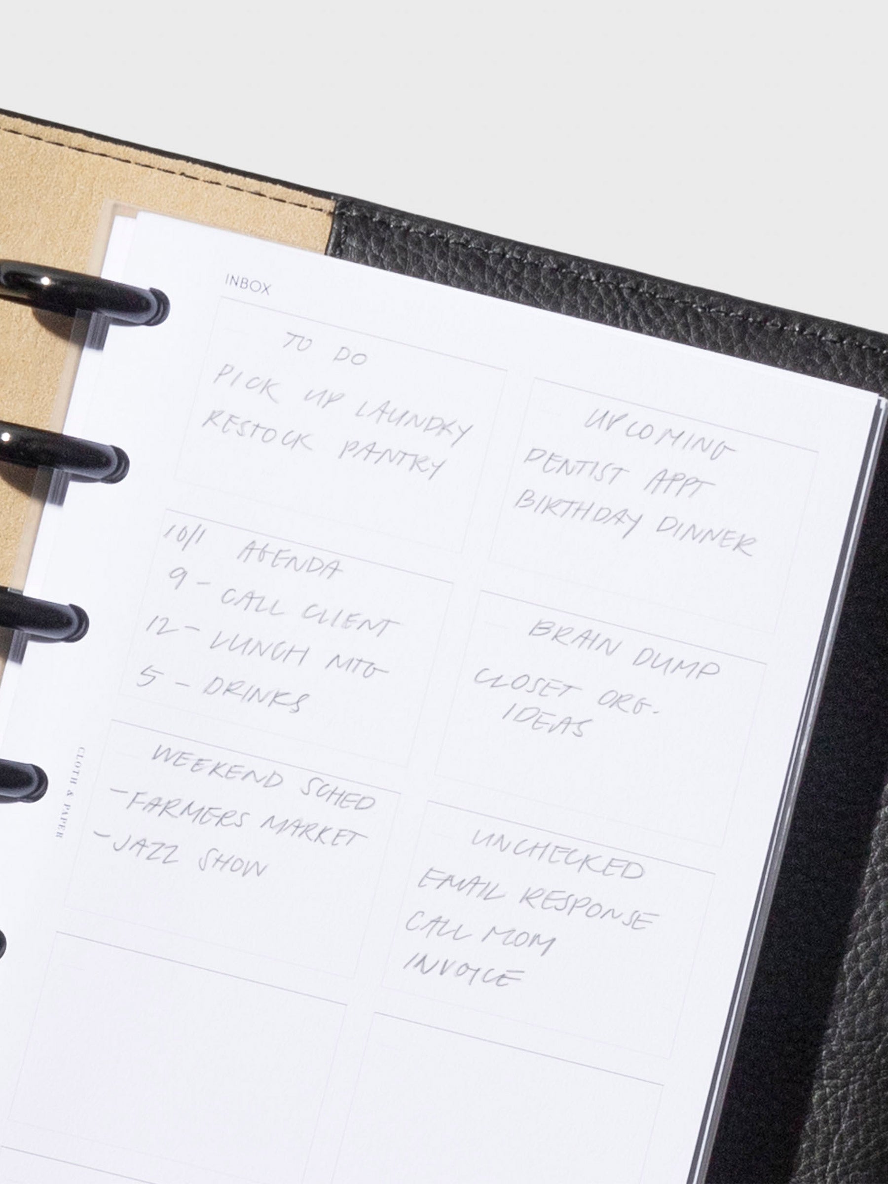 Closeup of insert in use inside a Small black leather folio. Sample text has been written on the insert in pencil.