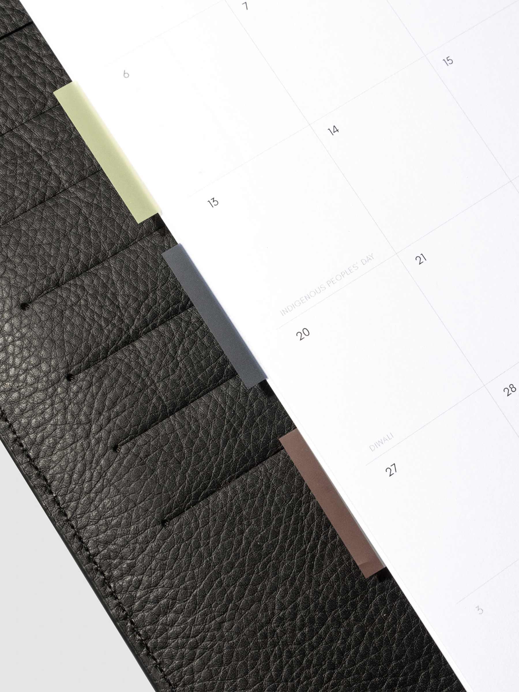 Set of 3 page flags in use inside a black leather planner.