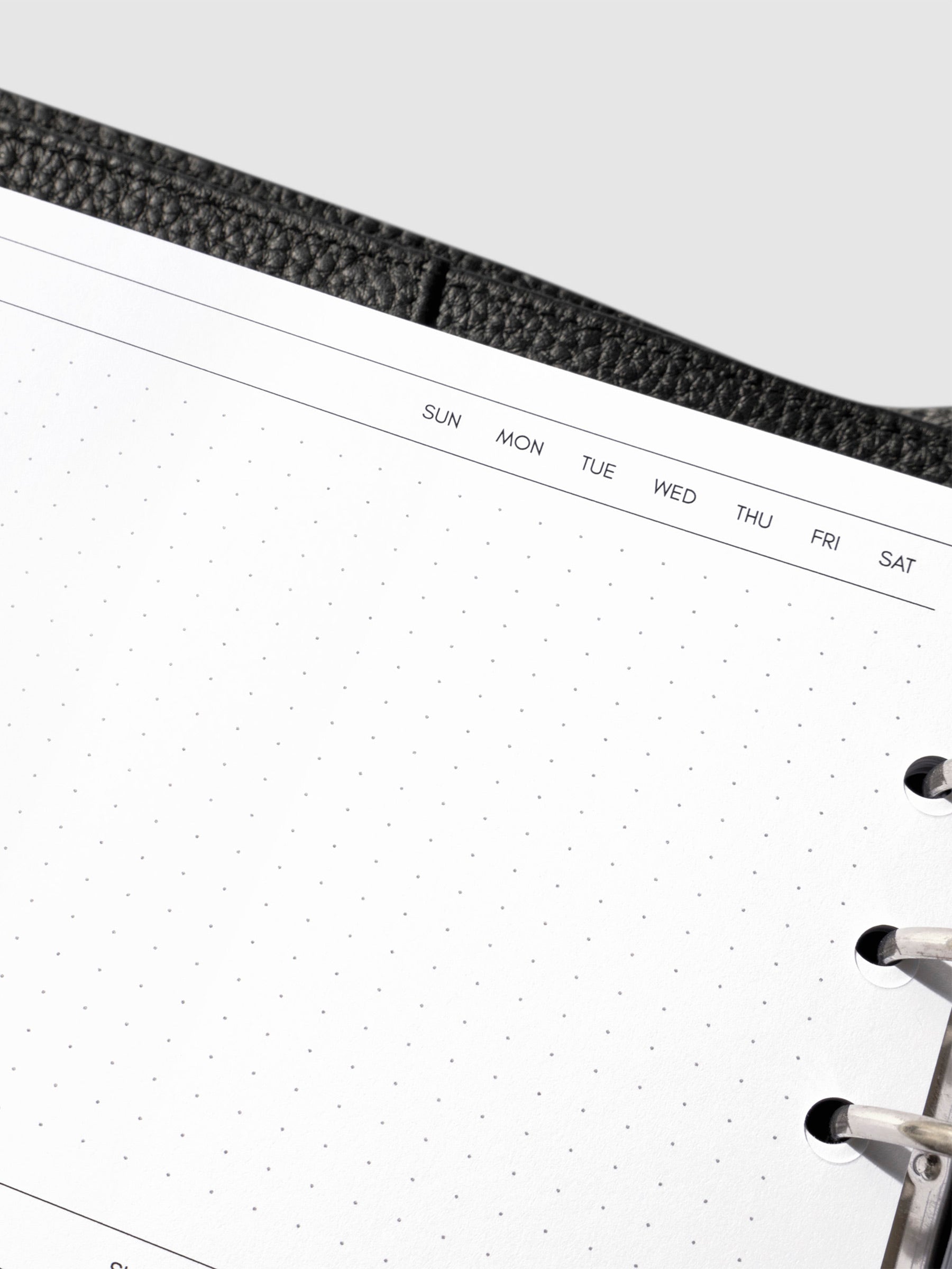 Closeup of inserts in use inside a leather planner.