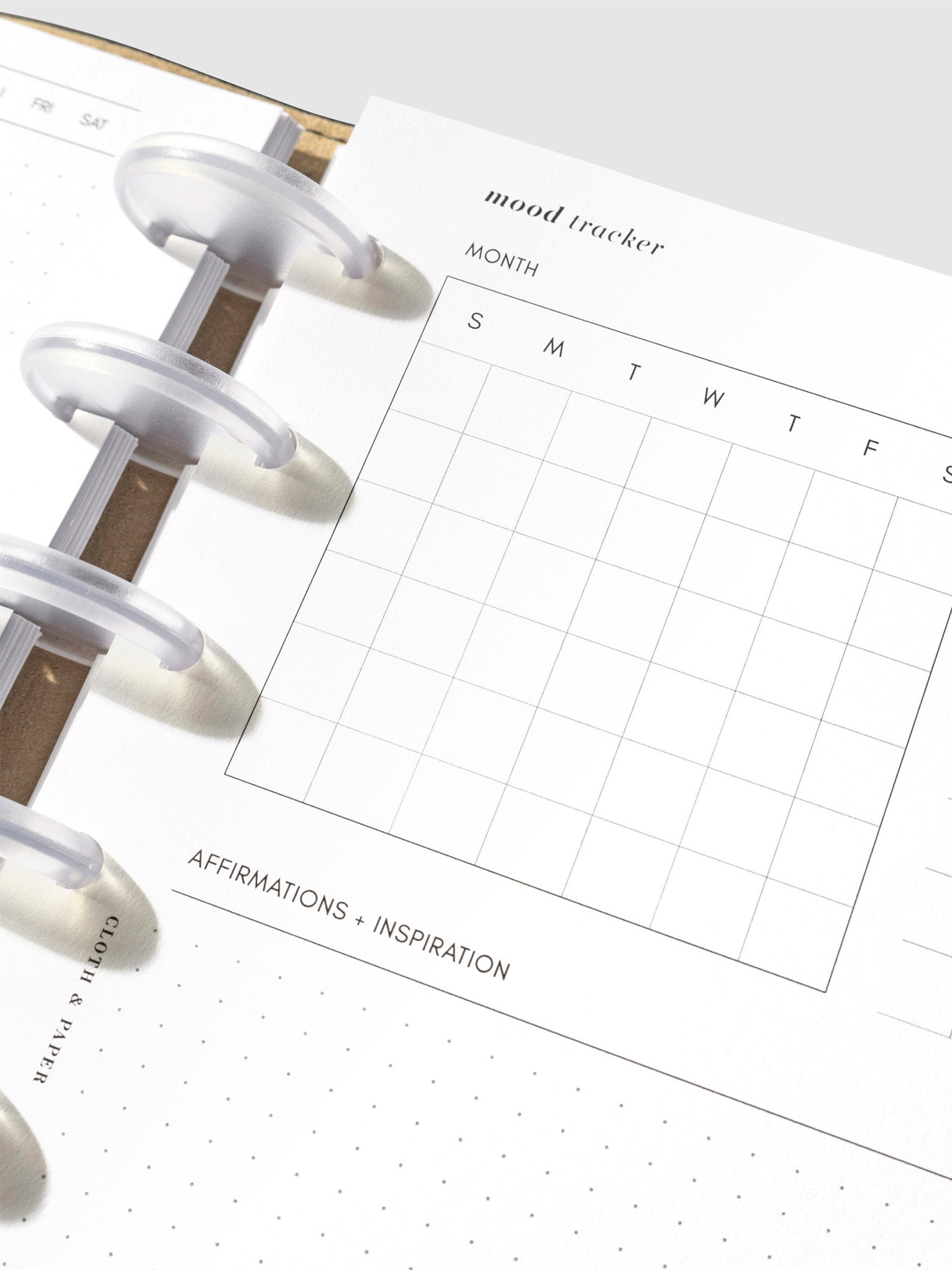 Close up of a page inside the inserts. Fields are monthly mood tracker, symbol key guide, and affirmations and inspiration.