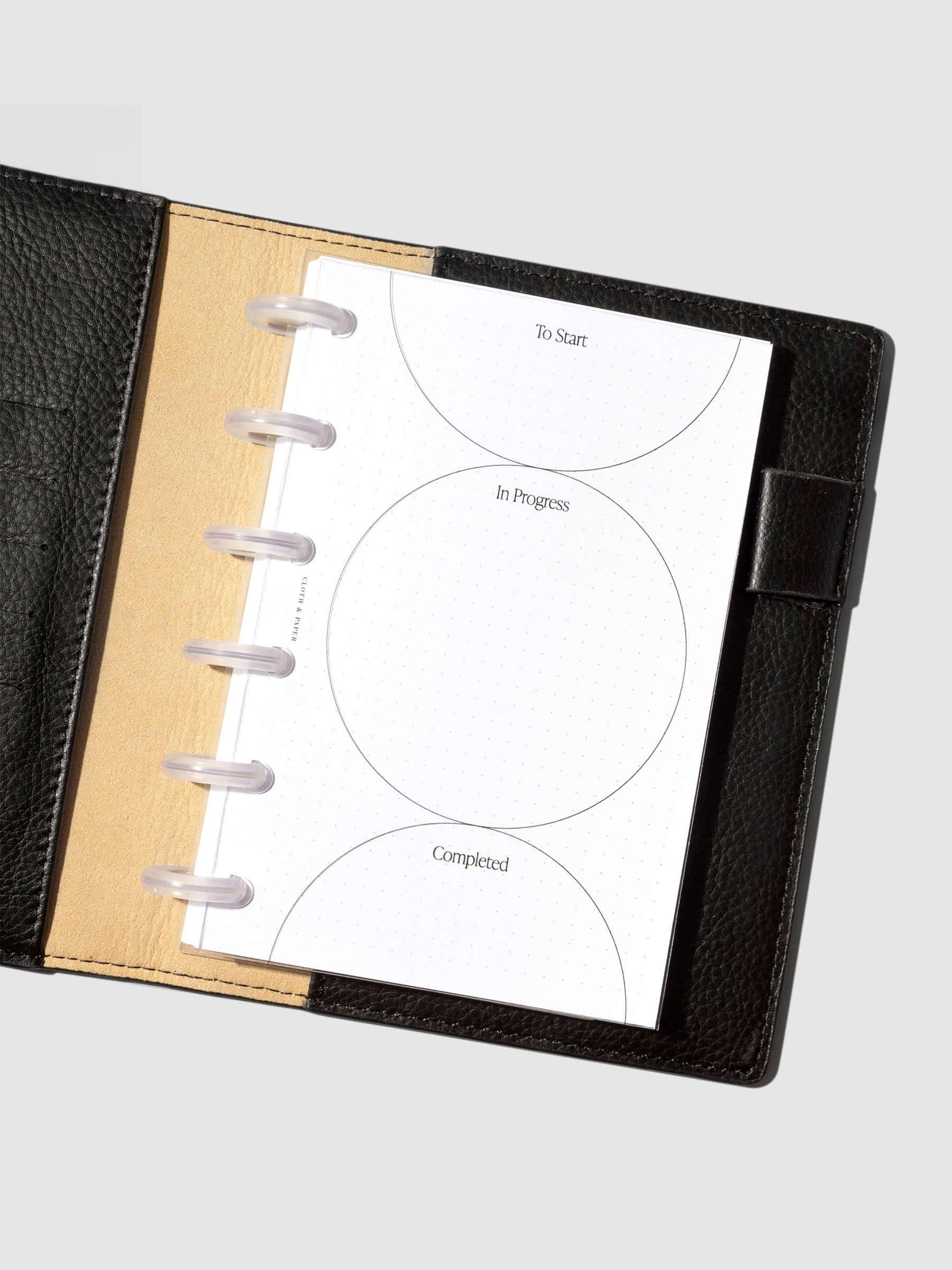Kanban planner dashboard inside a black leather planner.