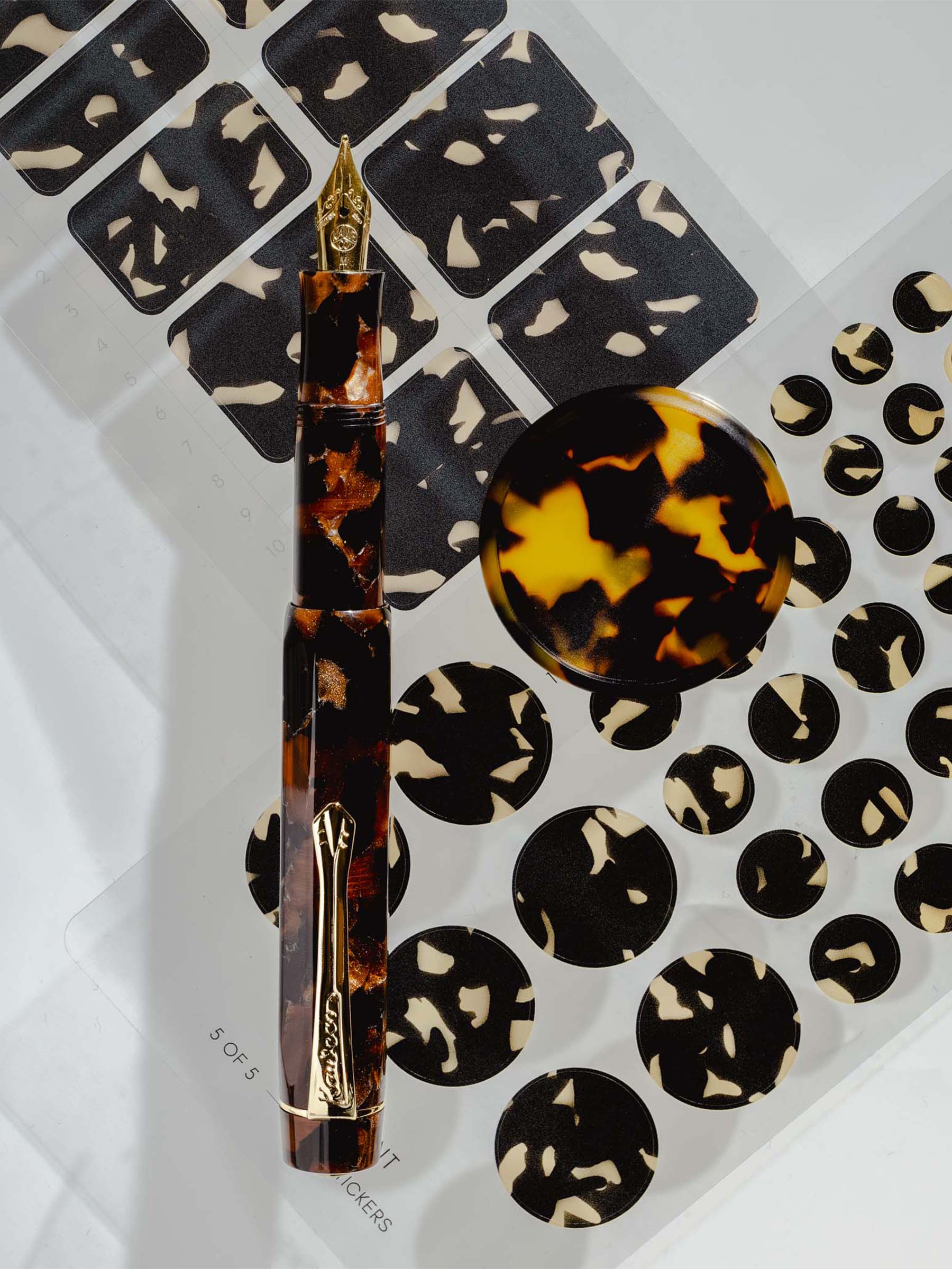 Kaweco Art Sport fountian pen showcased next to Tortoiseshell stickers and a Tortoiseshell planner disc.