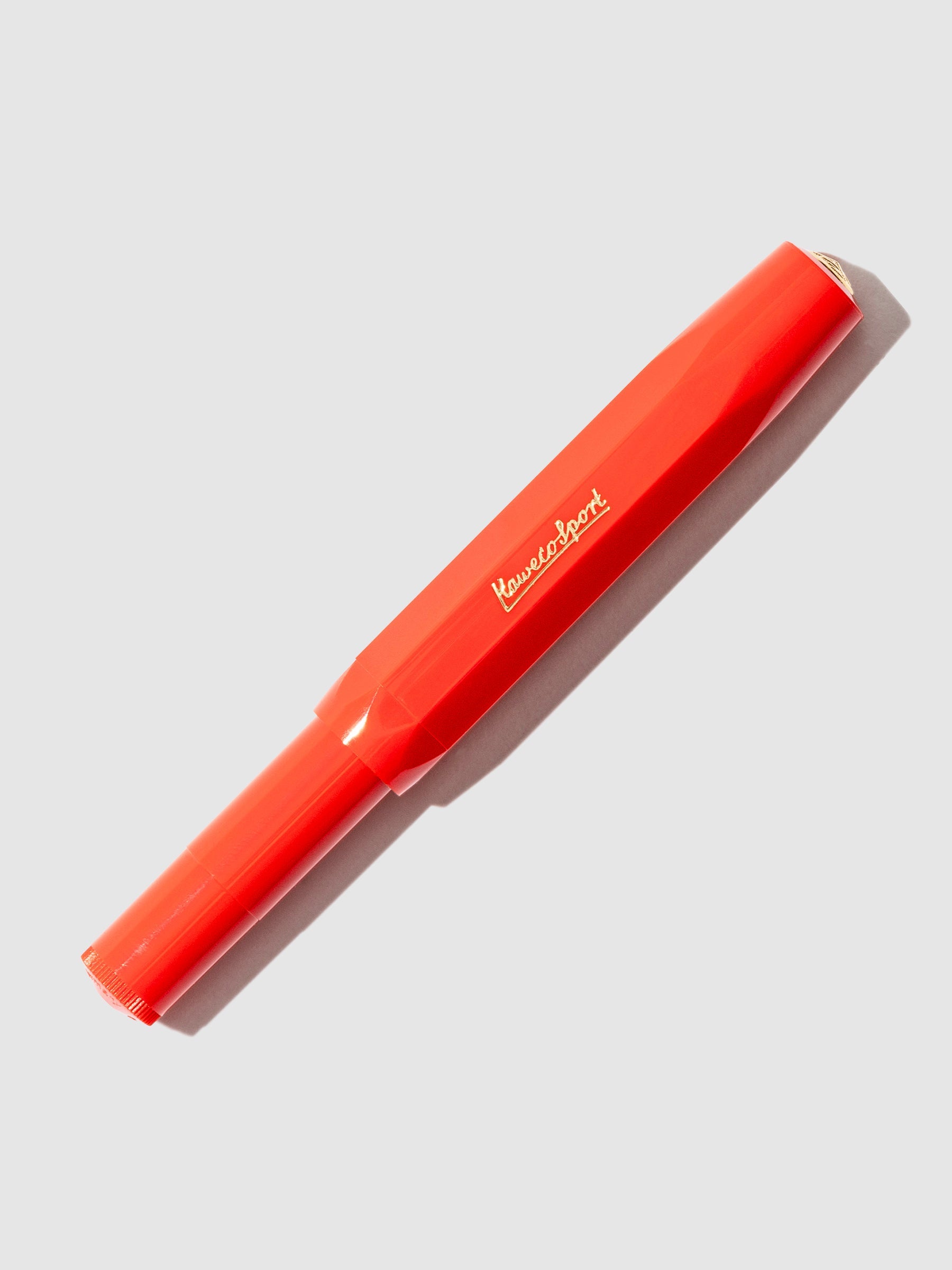 Red pen displayed on a neutral background.