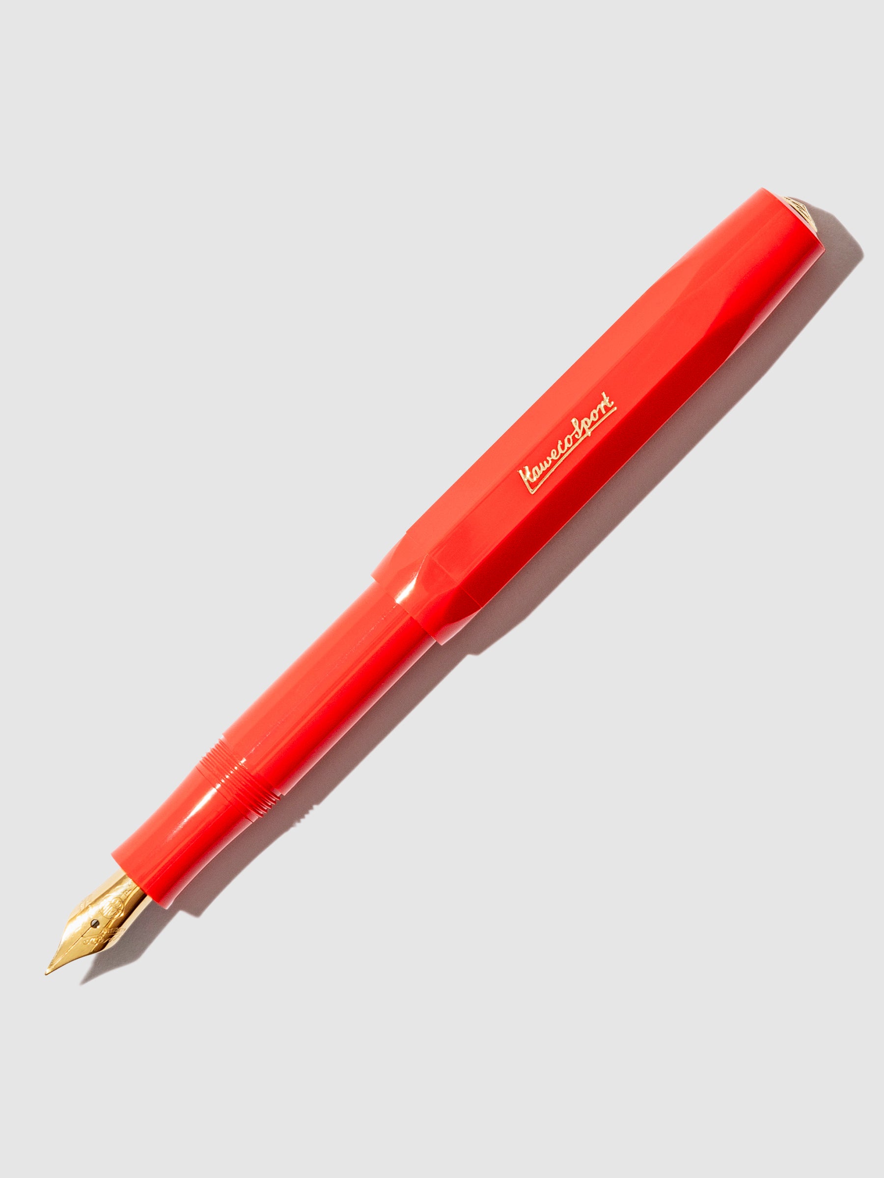 Kaweco Classic Sport Fountain Pen, Fine Nib, Red, Cloth and Paper. Pen displayed on a neutral background. The pen's nib is exposed.