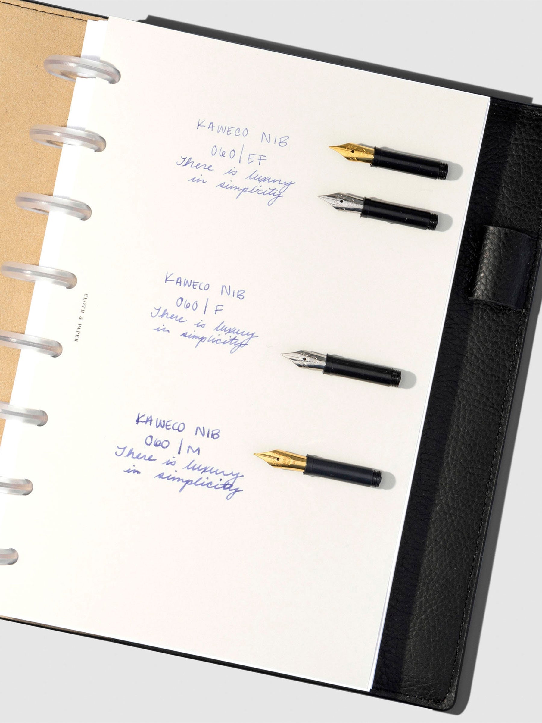 Writing sample displayed inside a black leather planner.