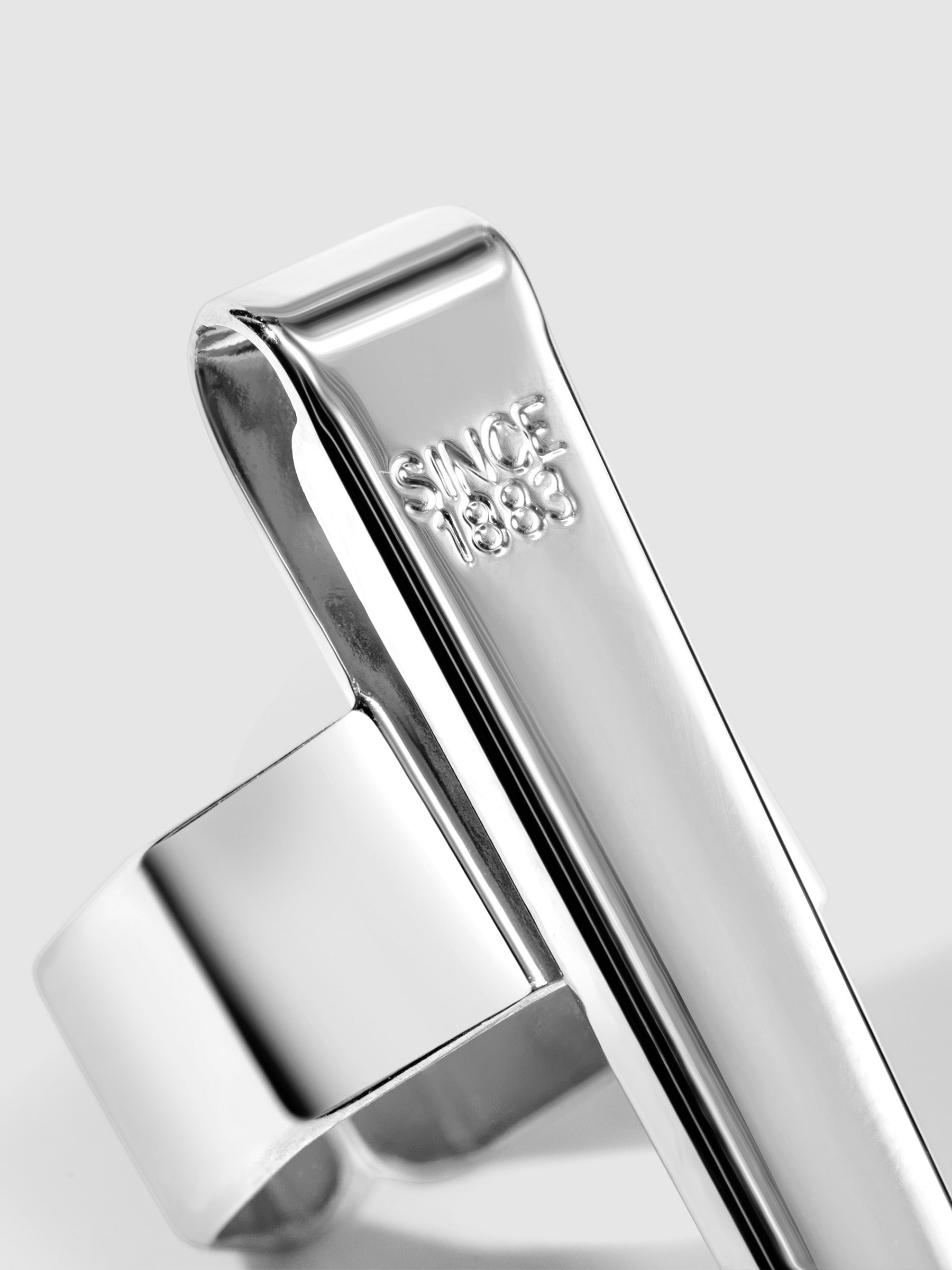 Standard silver clip displayed on a neutral background. Closeup of text reads "Since 1883"