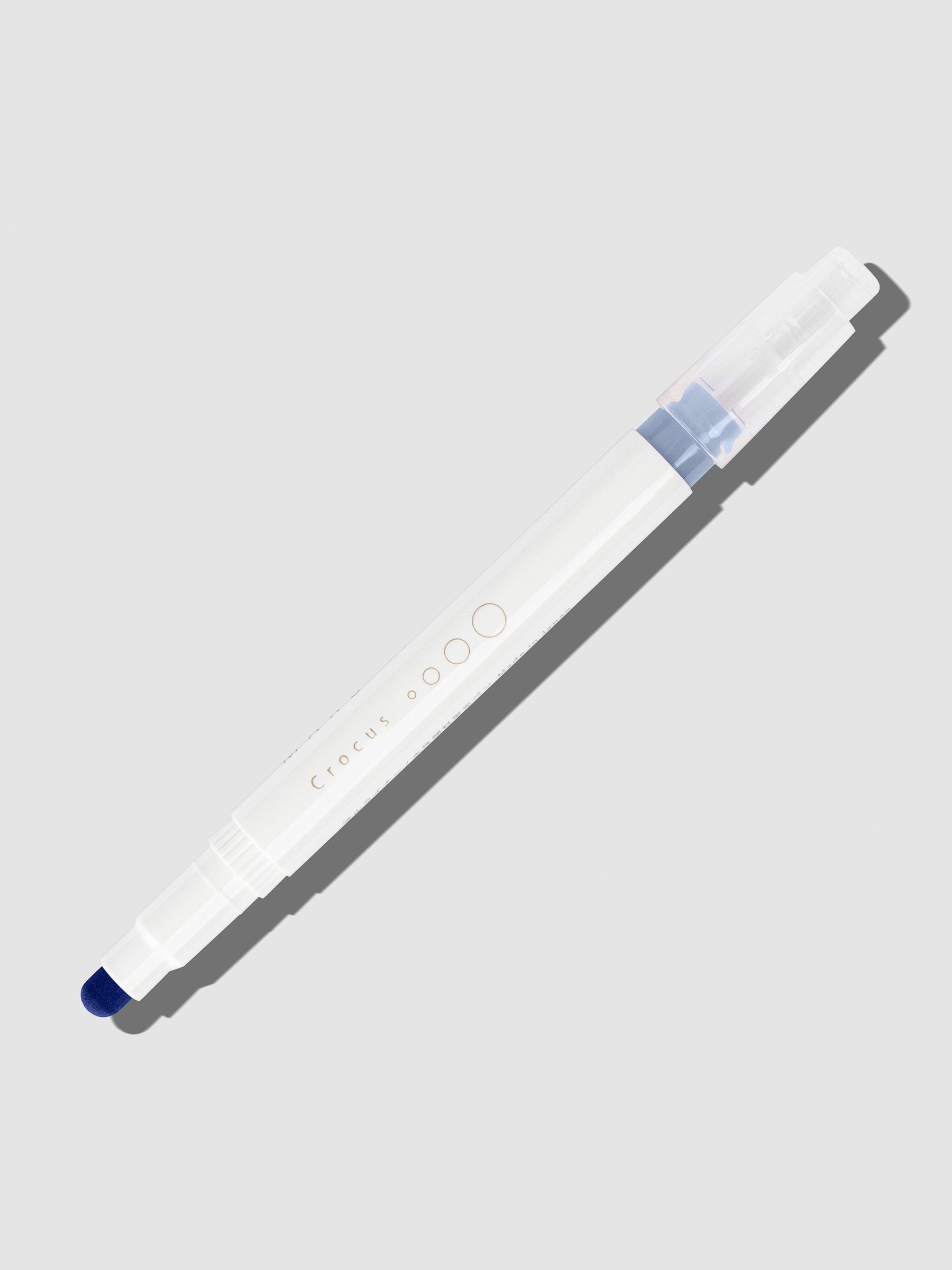 Crocus highlighter with tip exposed and cap posted to the end of its barrel on a neutral background.