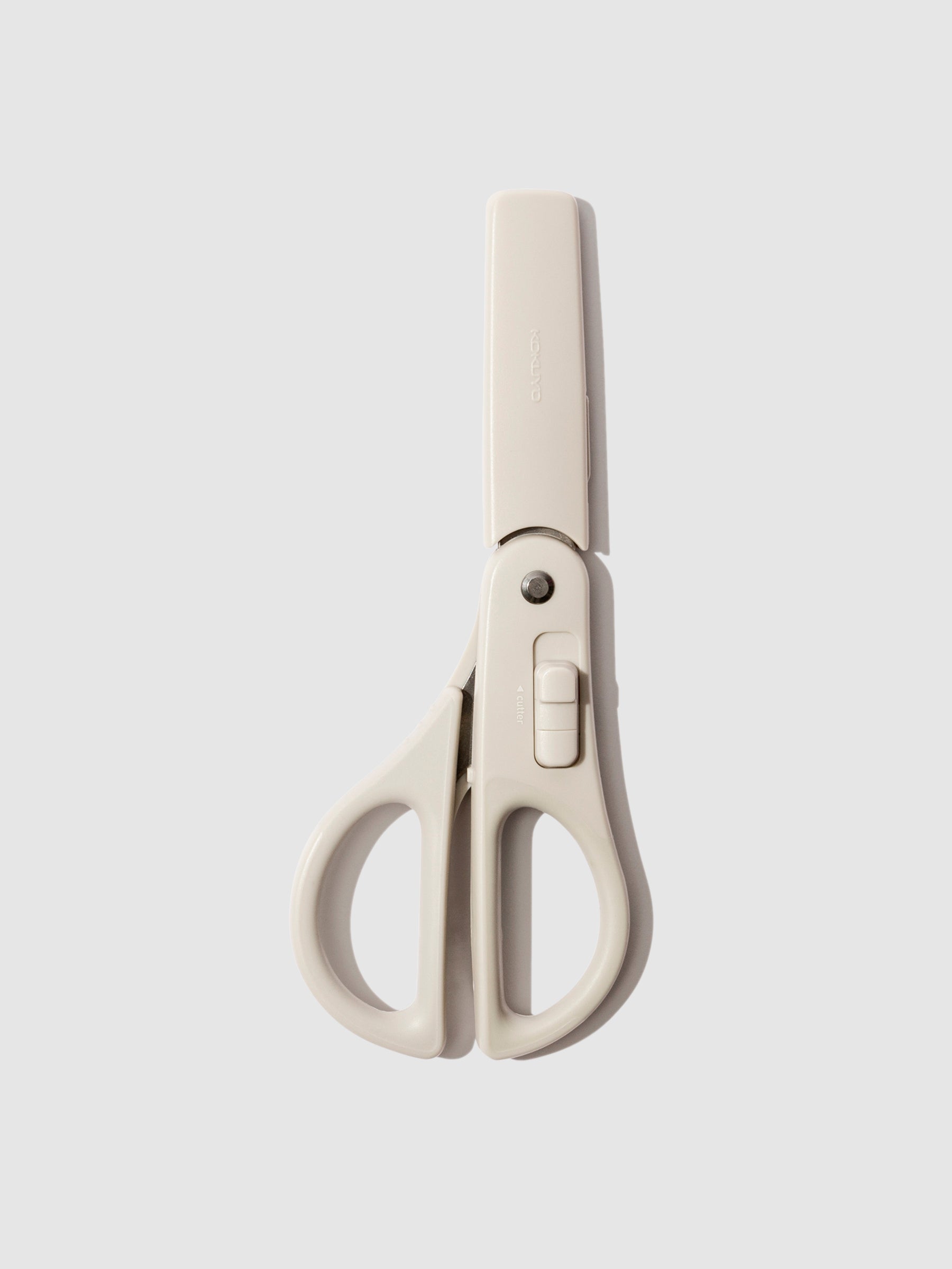 Kokuyo Hacoake 2-Way Scissors, Light Gray, Cloth and Paper. Scissors displayed sheathed on a neutral background.