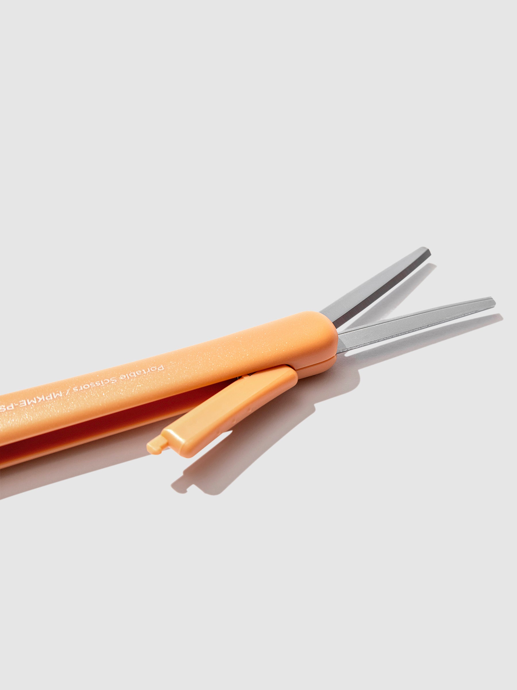 Closeup of scissors with blade exposed, showing the mechanism that exposes the scissor blades. Color shown is Kurumi Brown.