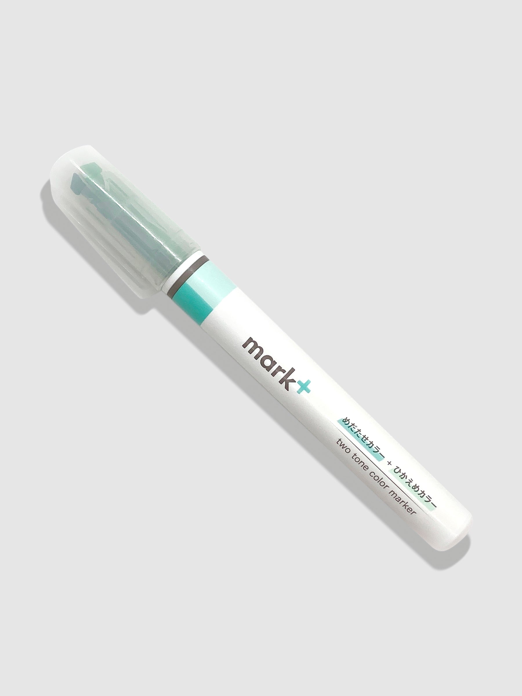 Kokuyo Mark Plus Two Tone Highlighter in Green turned to the left against a neutral background.