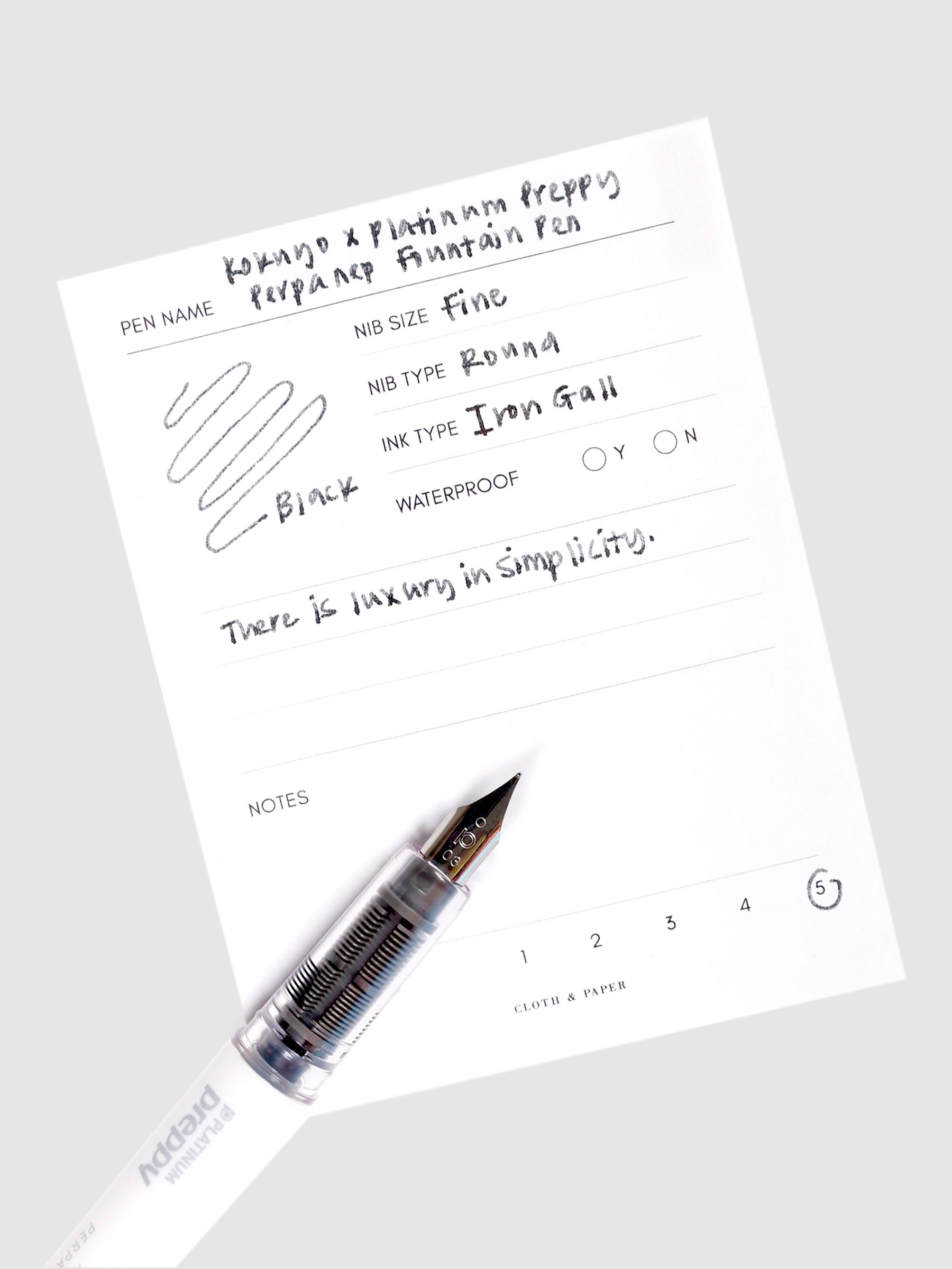 Kokuyo x Platinum Preppy Perpanep Fountain Pen, Cloth and Paper. Pen resting on pen test sheet displaying writing sample.