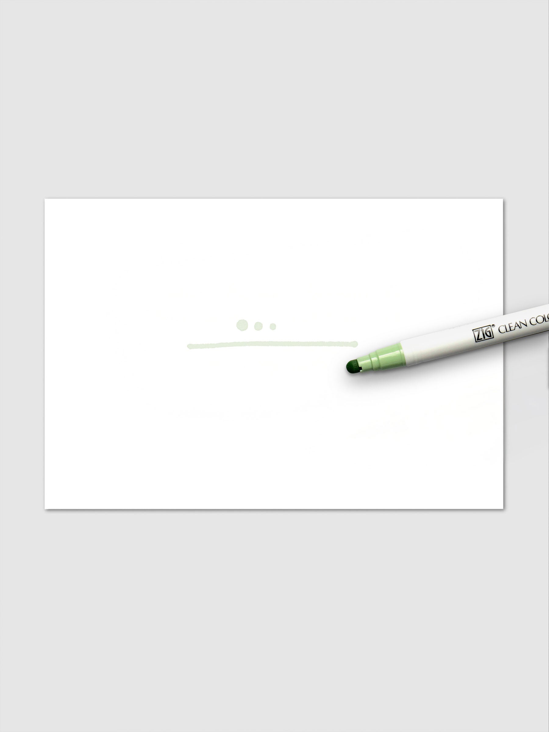 Pale Moss marker shown in use with light green dots and a fine line drawn on a white paper background.