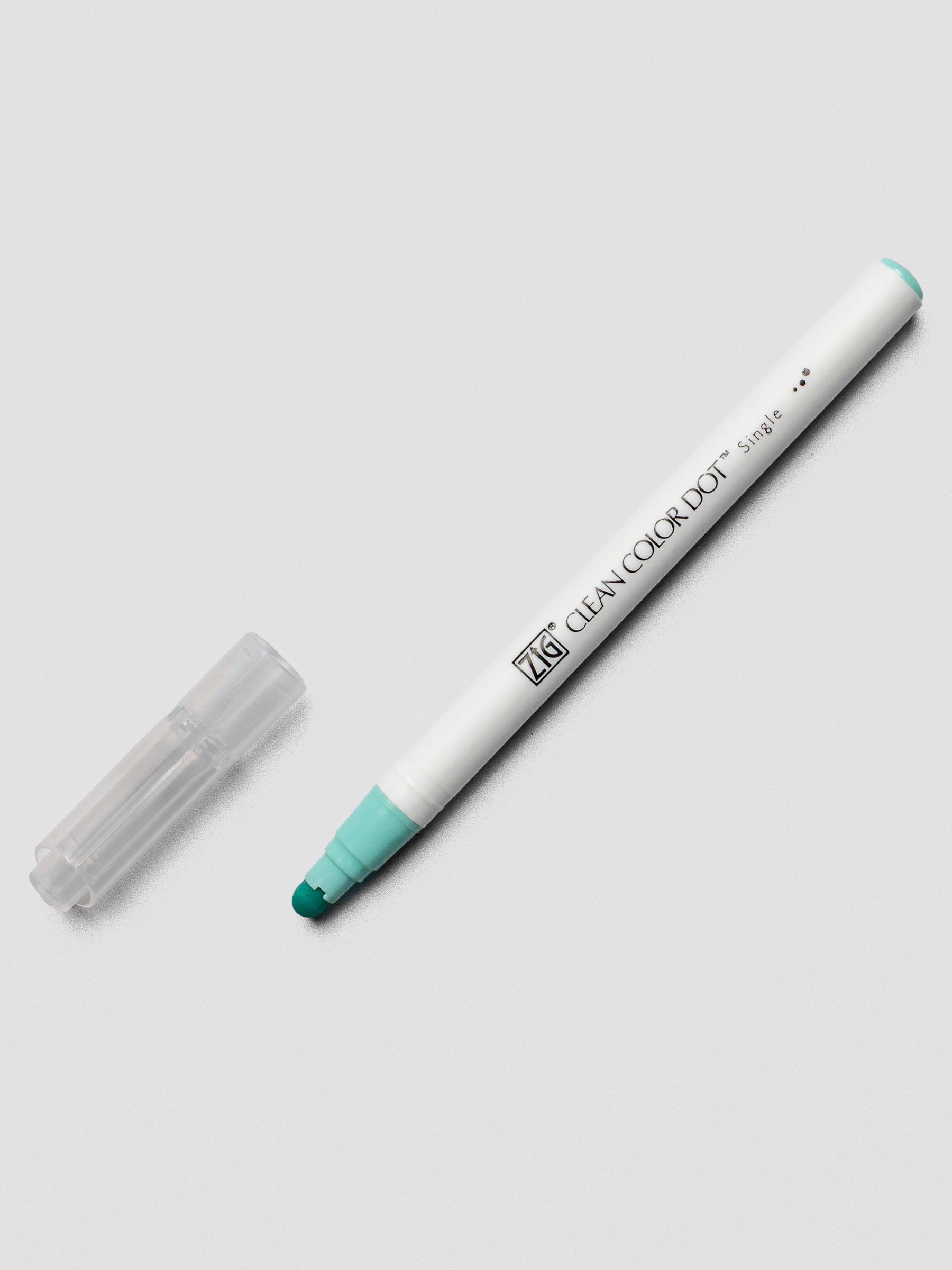 A Kuretake ZIG Clean Color Dot Marker in Pale Turquoise, uncapped to show the flexible dot tip and its signature white plastic body.