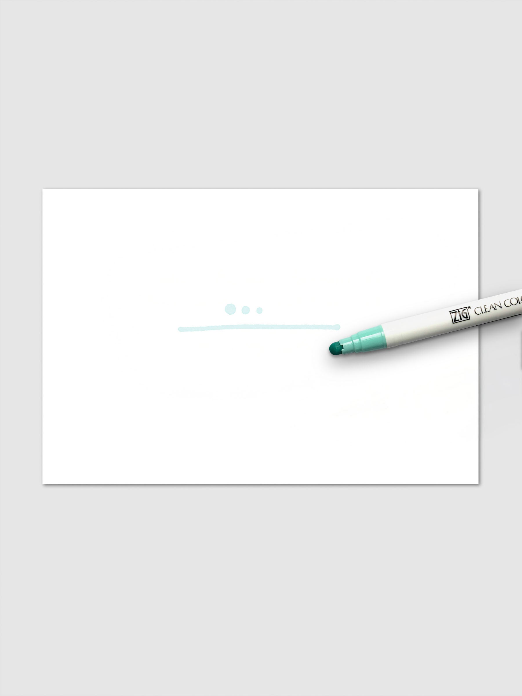 A light turquoise marker line and three dots on white paper, made with the Pale Turquoise Clean Color Dot Marker shown alongside.
