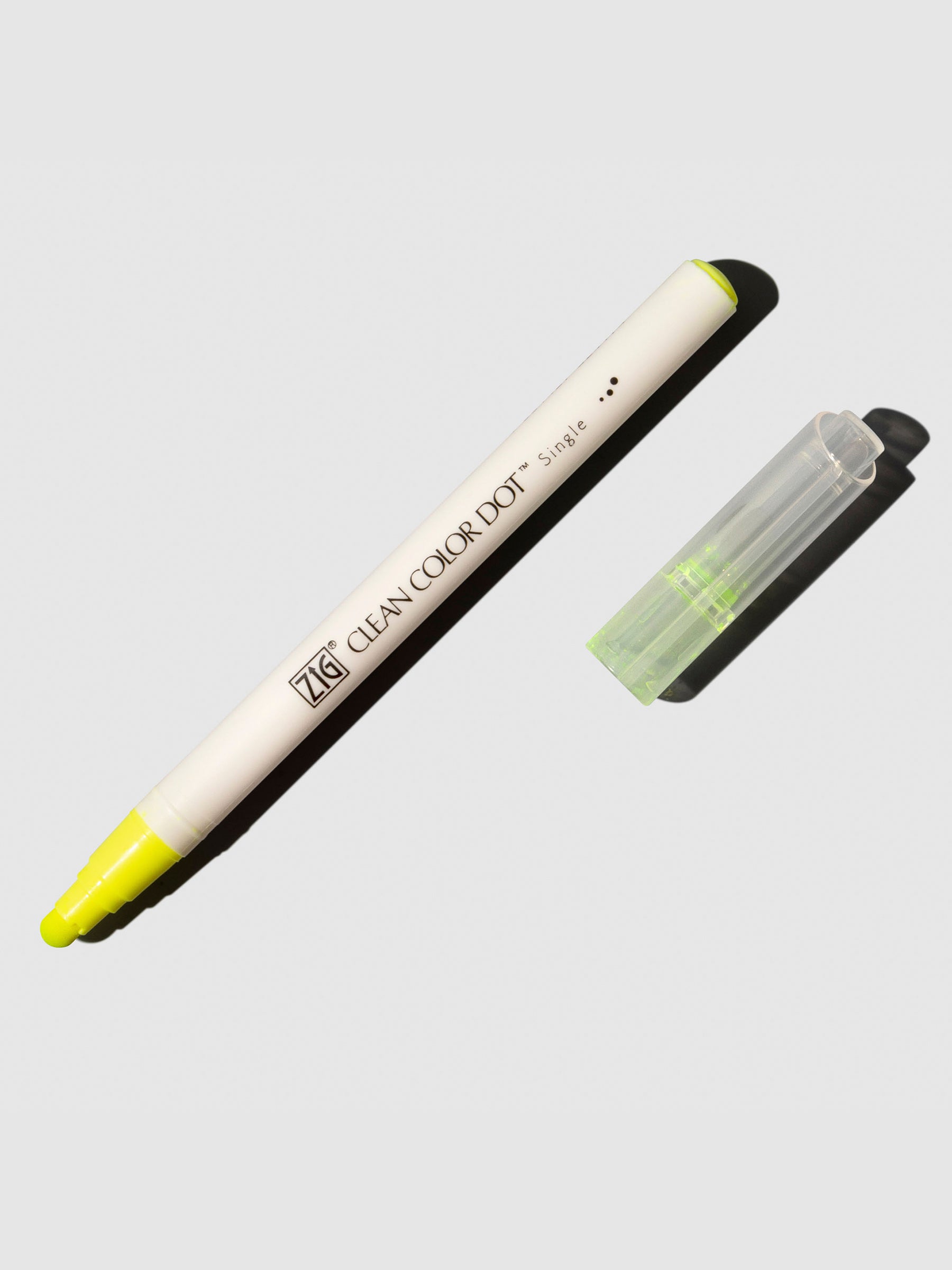 Kuretake Zig Clean Color Dot Marker in Yellow displayed uncapped on a neutral background.