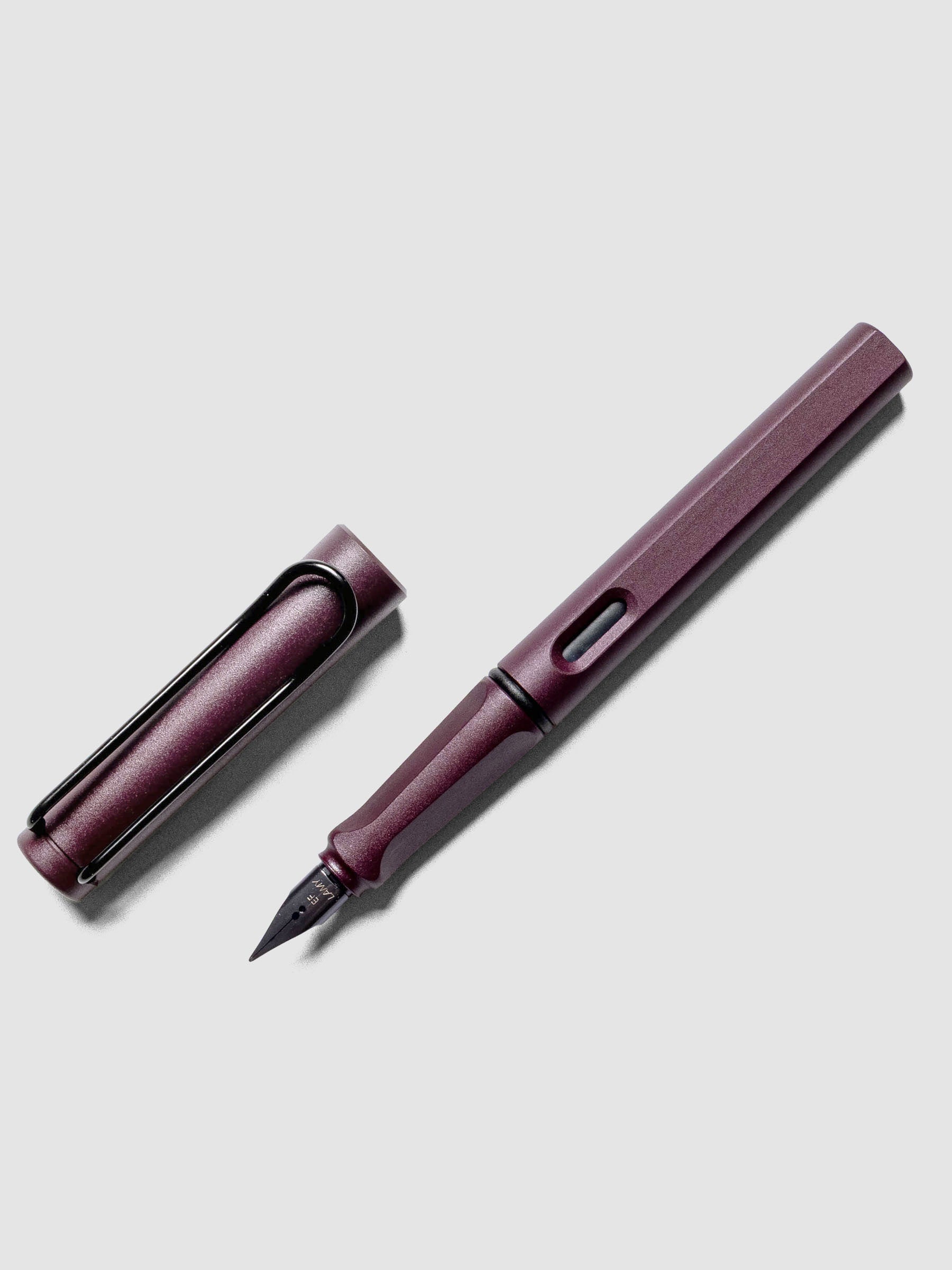 LAMY Safari Fountain Pen in the color Scarlett with Extra Fine nib shown diagonally with the cap off.