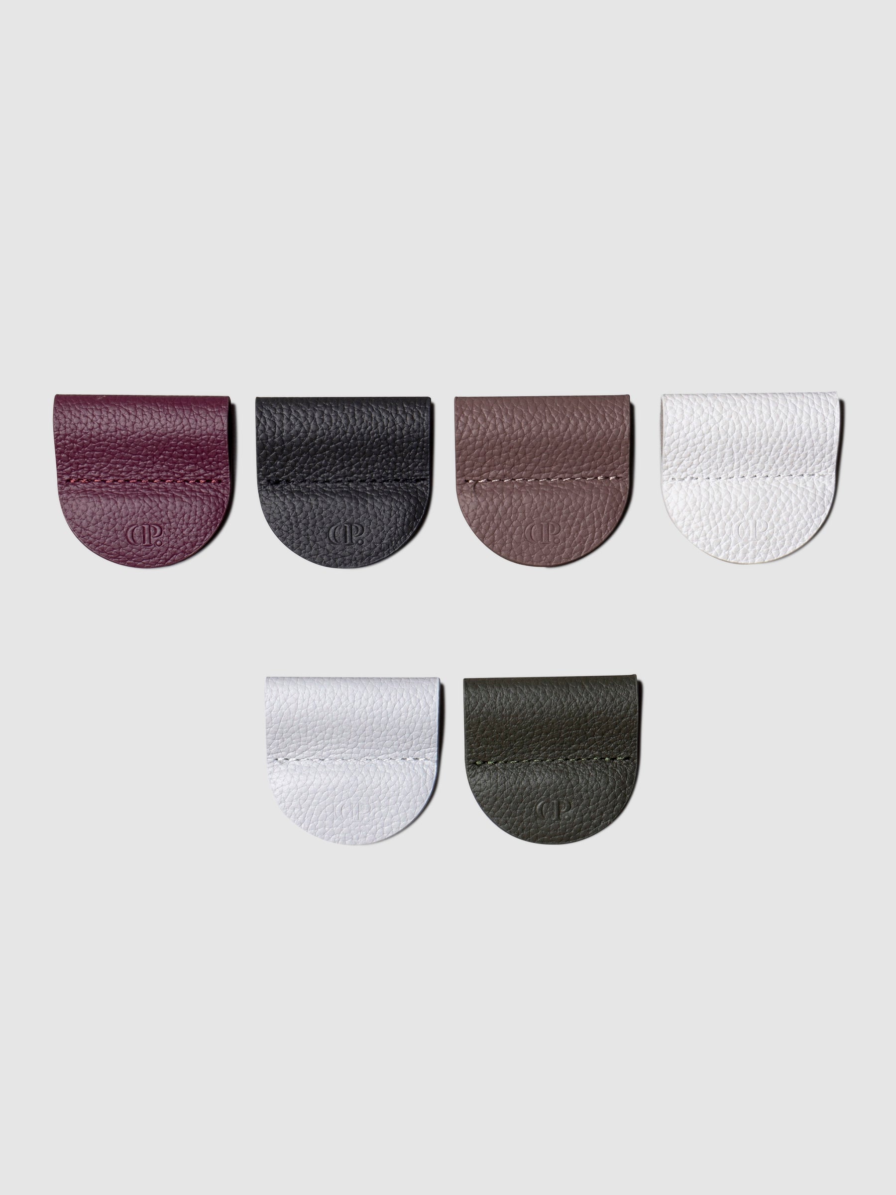 Image shows 6 pen clips in different colors on a white background