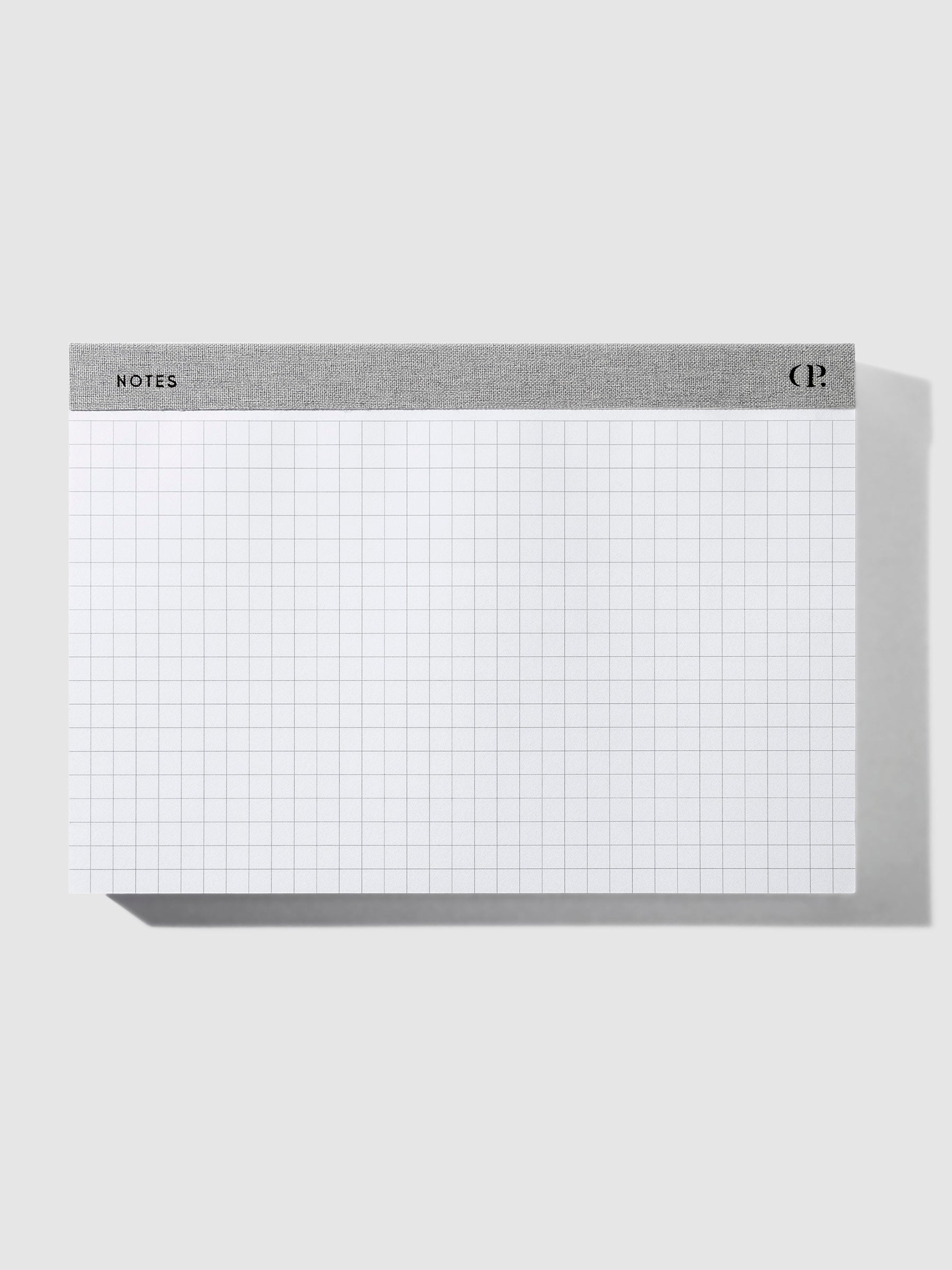 Notepad positioned horizontally on a neutral background.