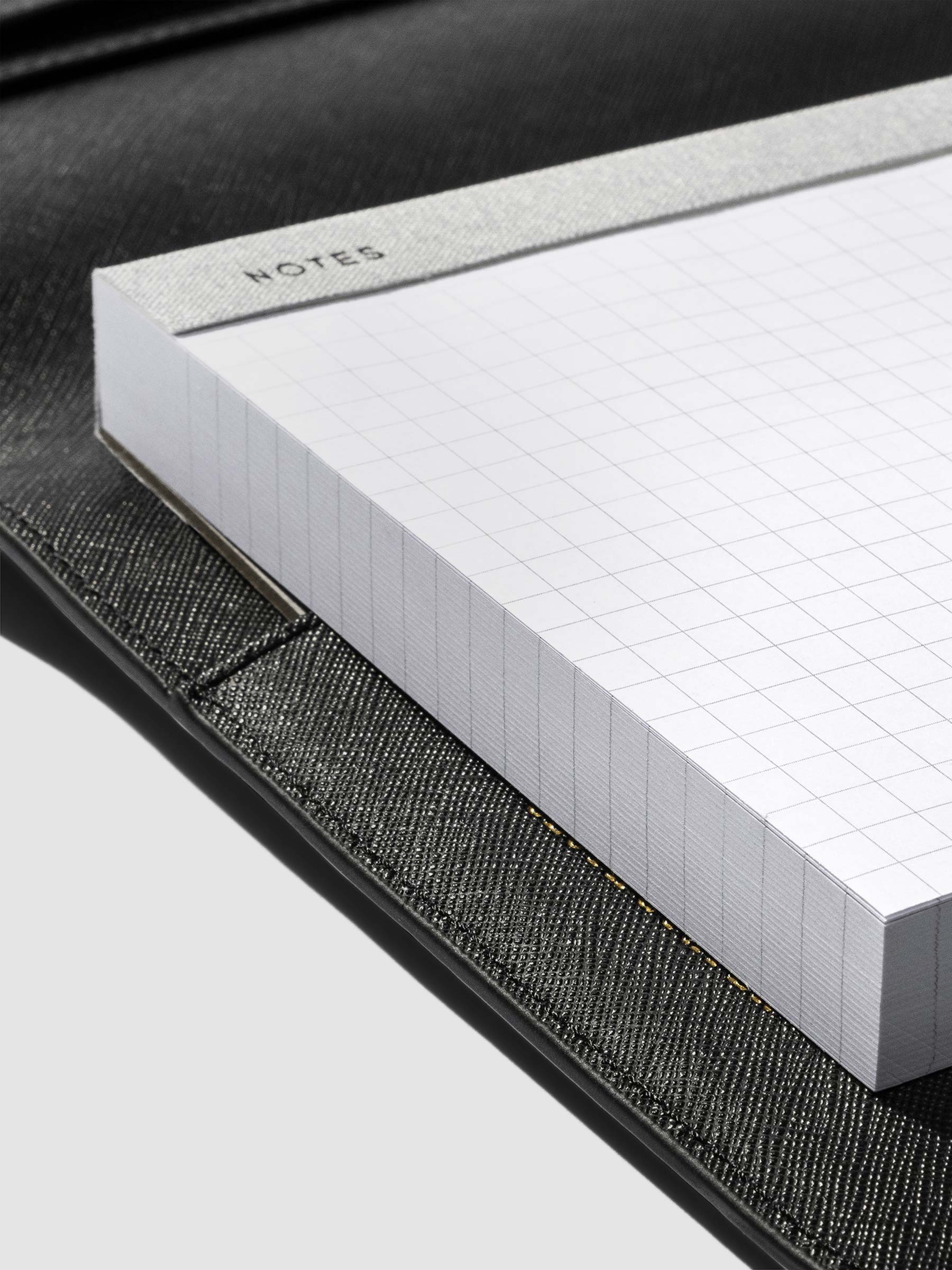 Notepad inside of a black leather folio.