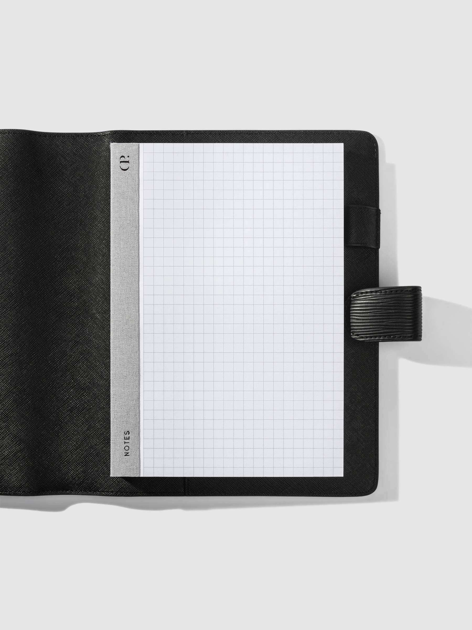 Notepad in use inside a black leather folio.