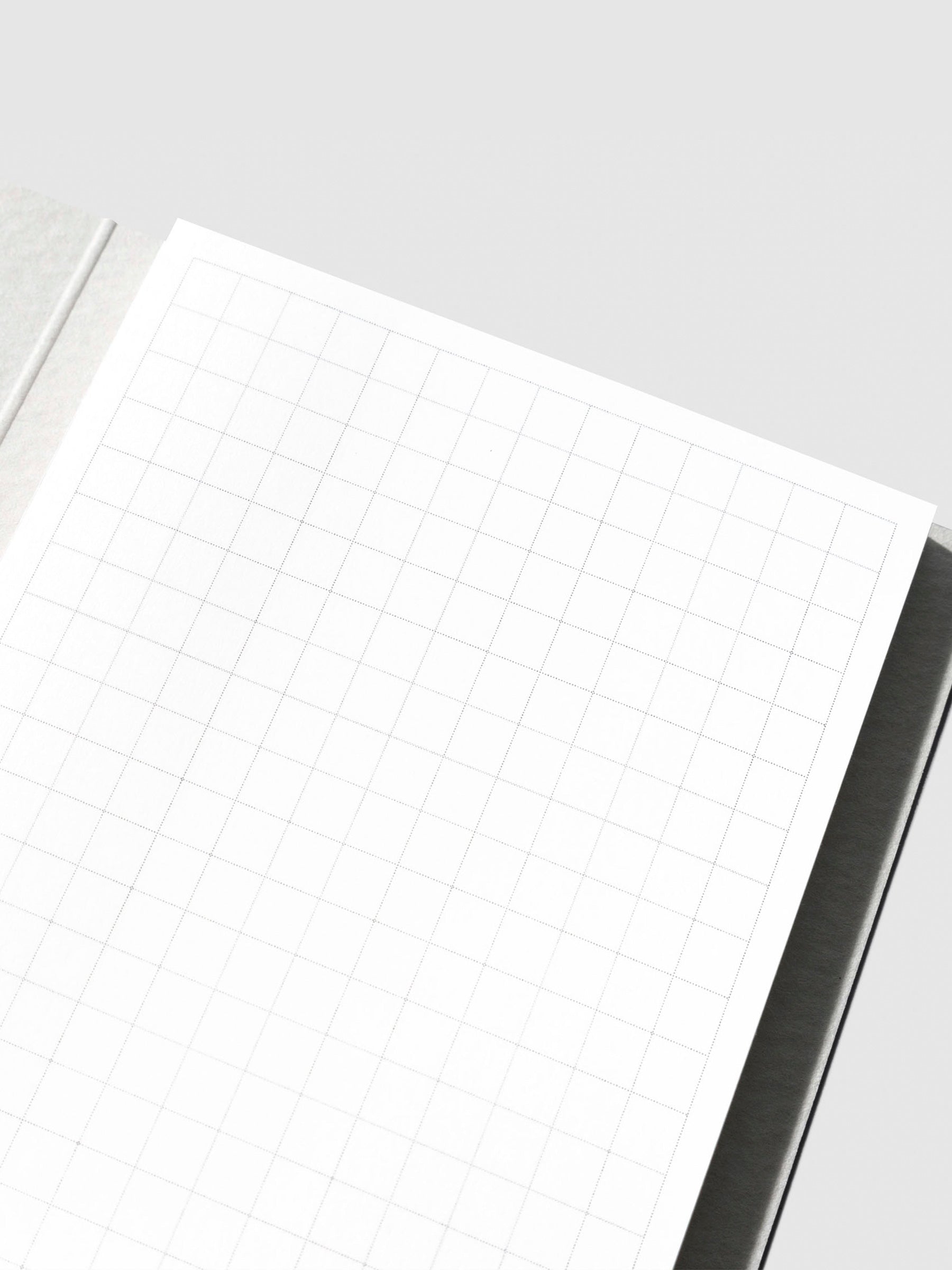 Closeup of sticky note in its packaging displayed on a neutral background.