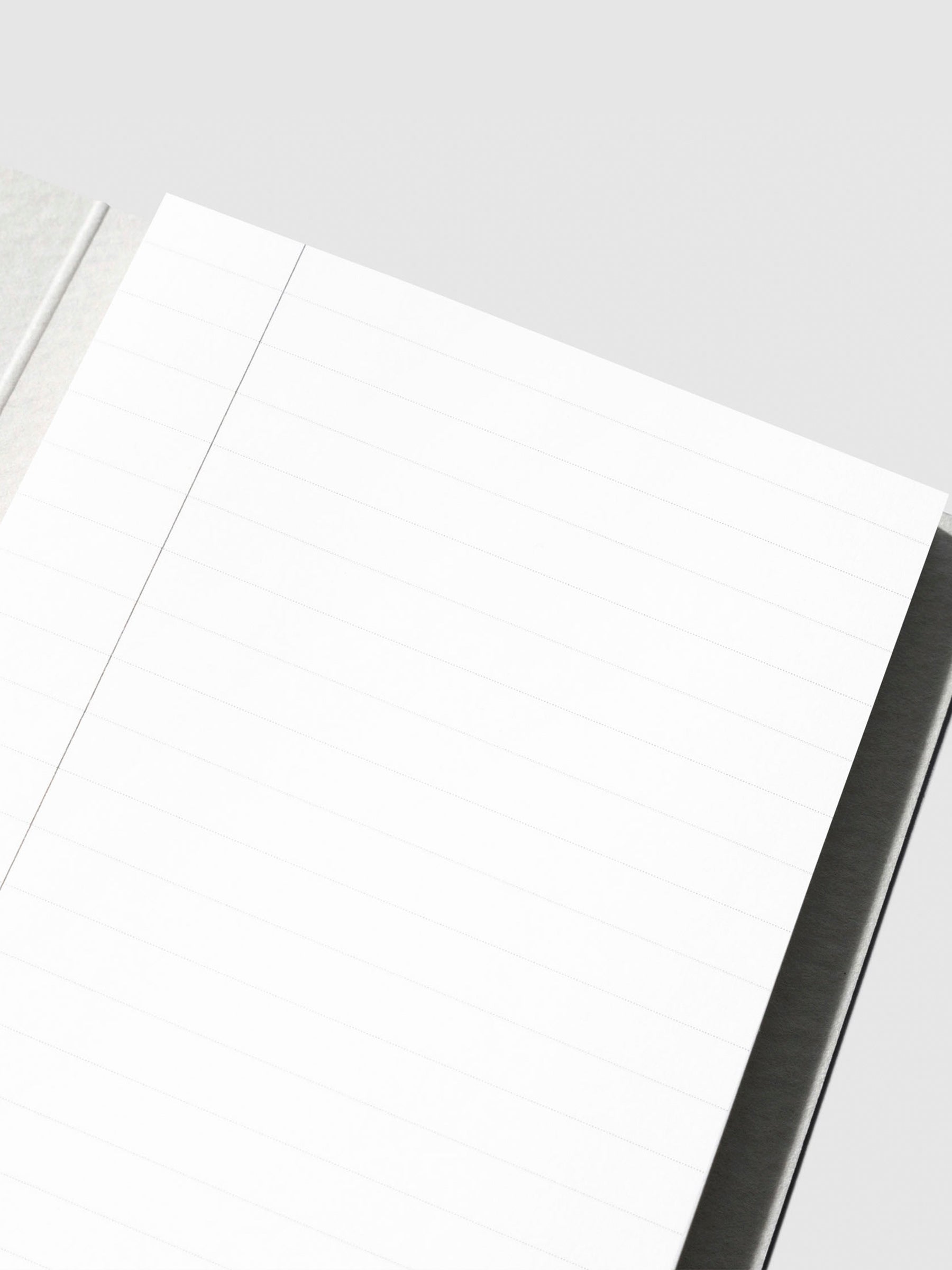 Closeup of sticky note in its packaging displayed on a neutral background.