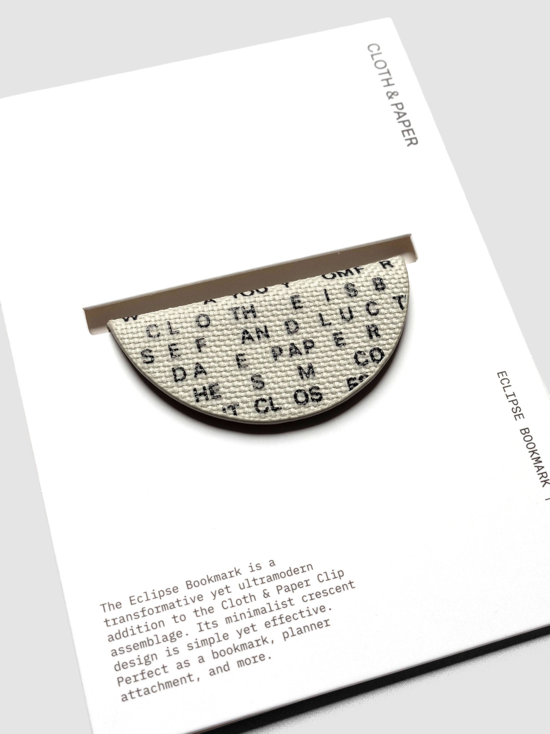 Magnetic Bookmark | Bookcloth | Letters shown in packaging, close up, on a neutral background.