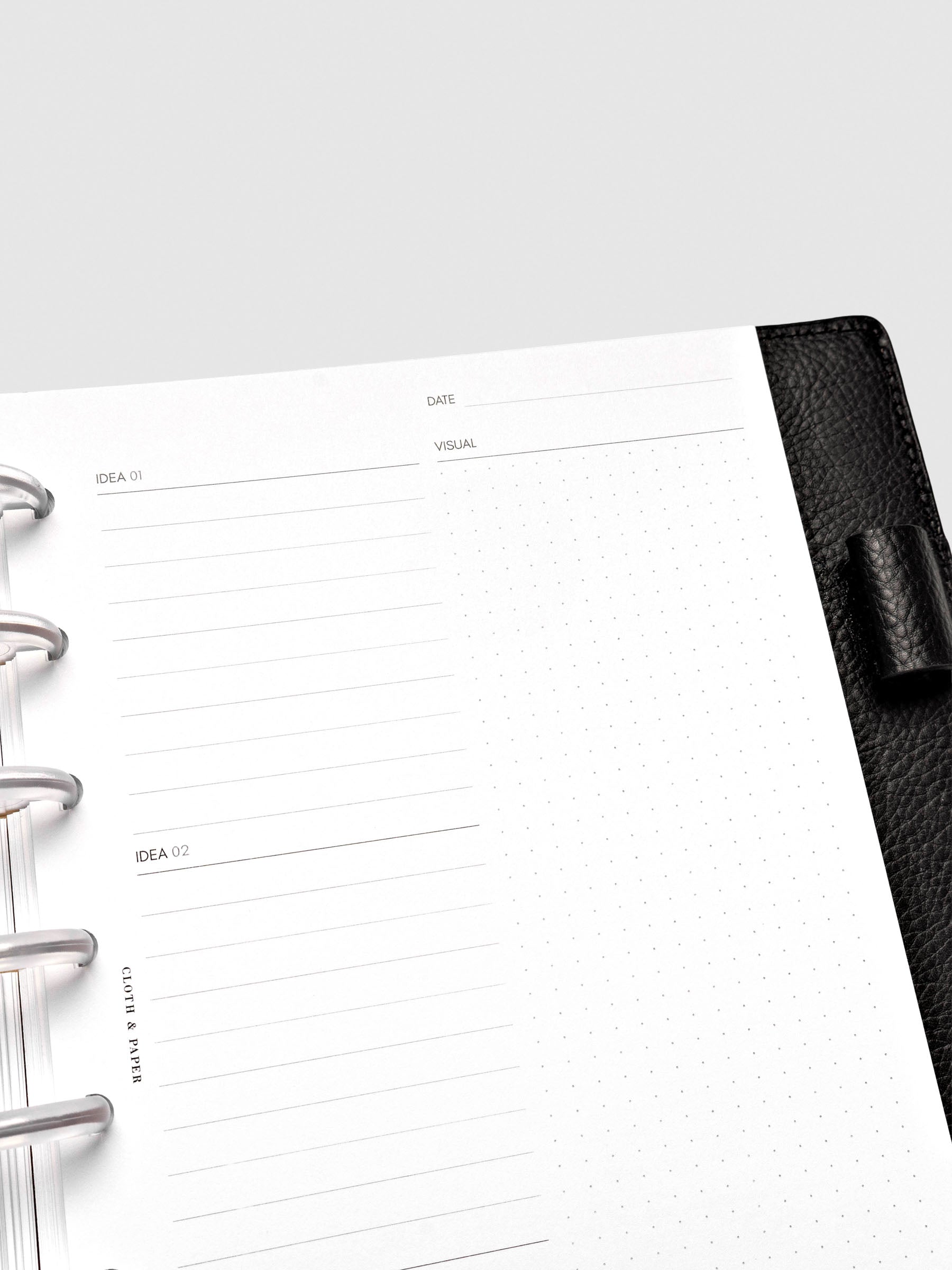 Close up of Mental Download inserts inside discbound planner and leather cover.