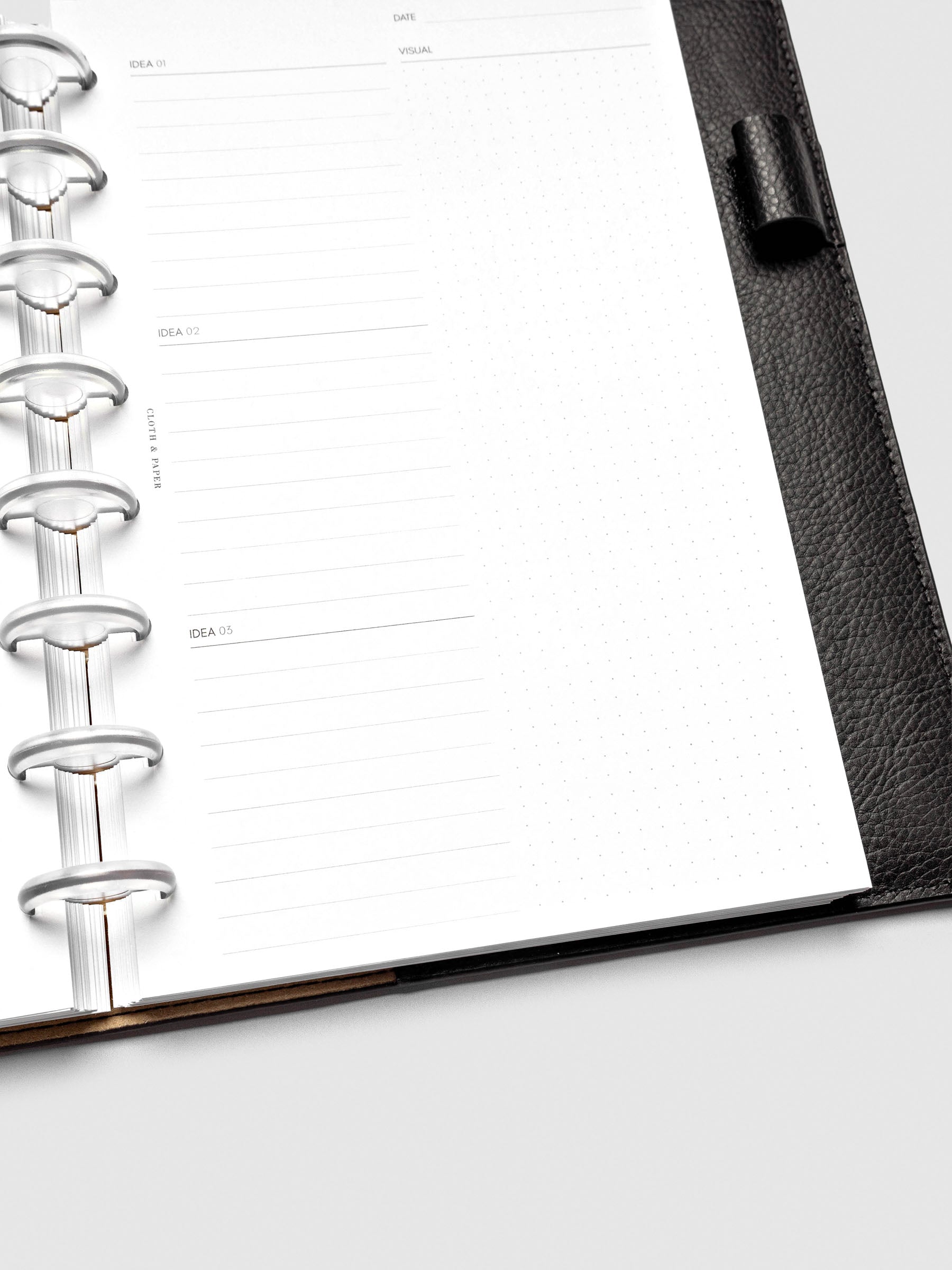 Close up of Mental Download inserts inside discbound planner and leather cover.