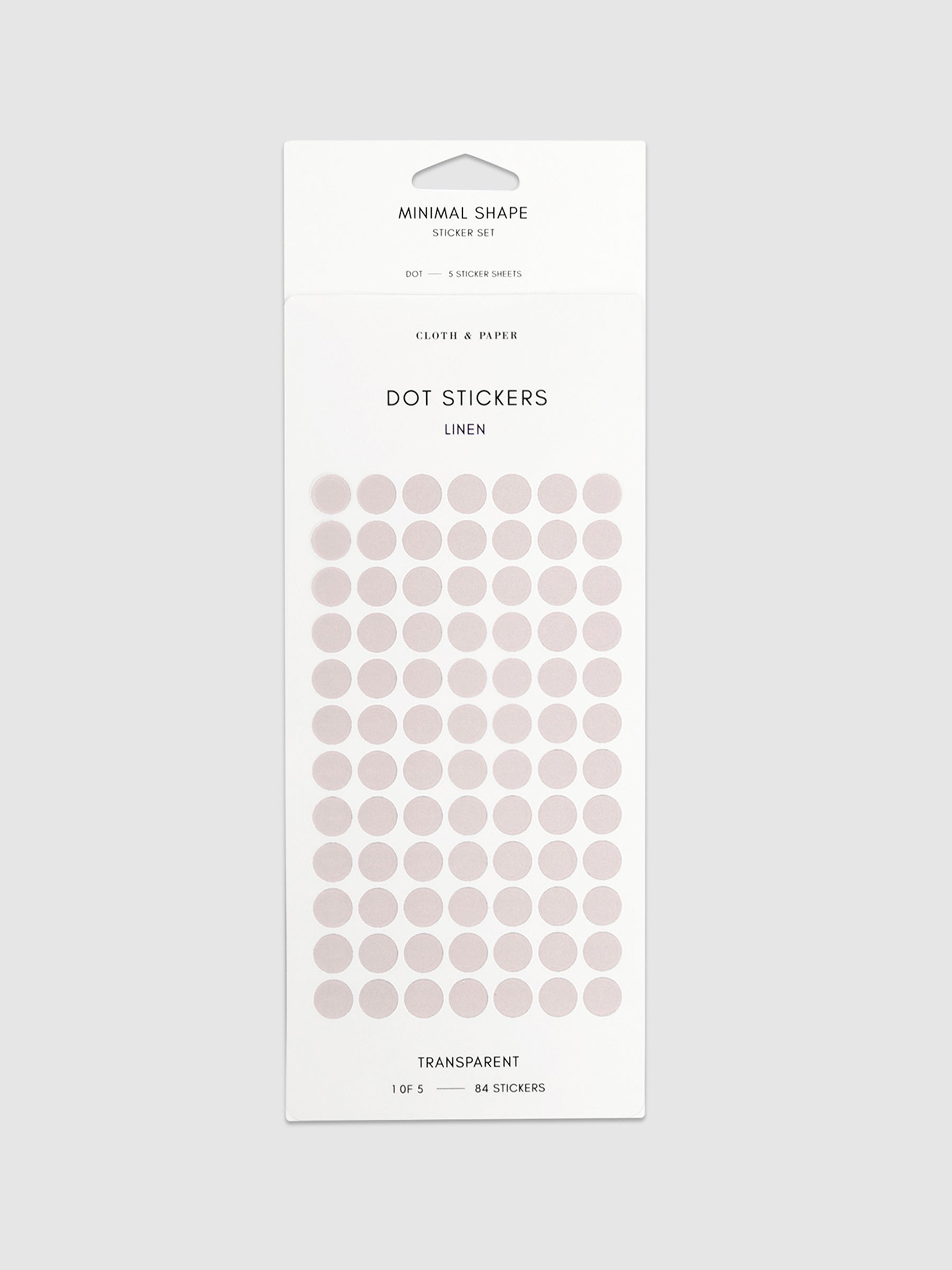Linen-colored dot stickers in their packaging on a neutral background.