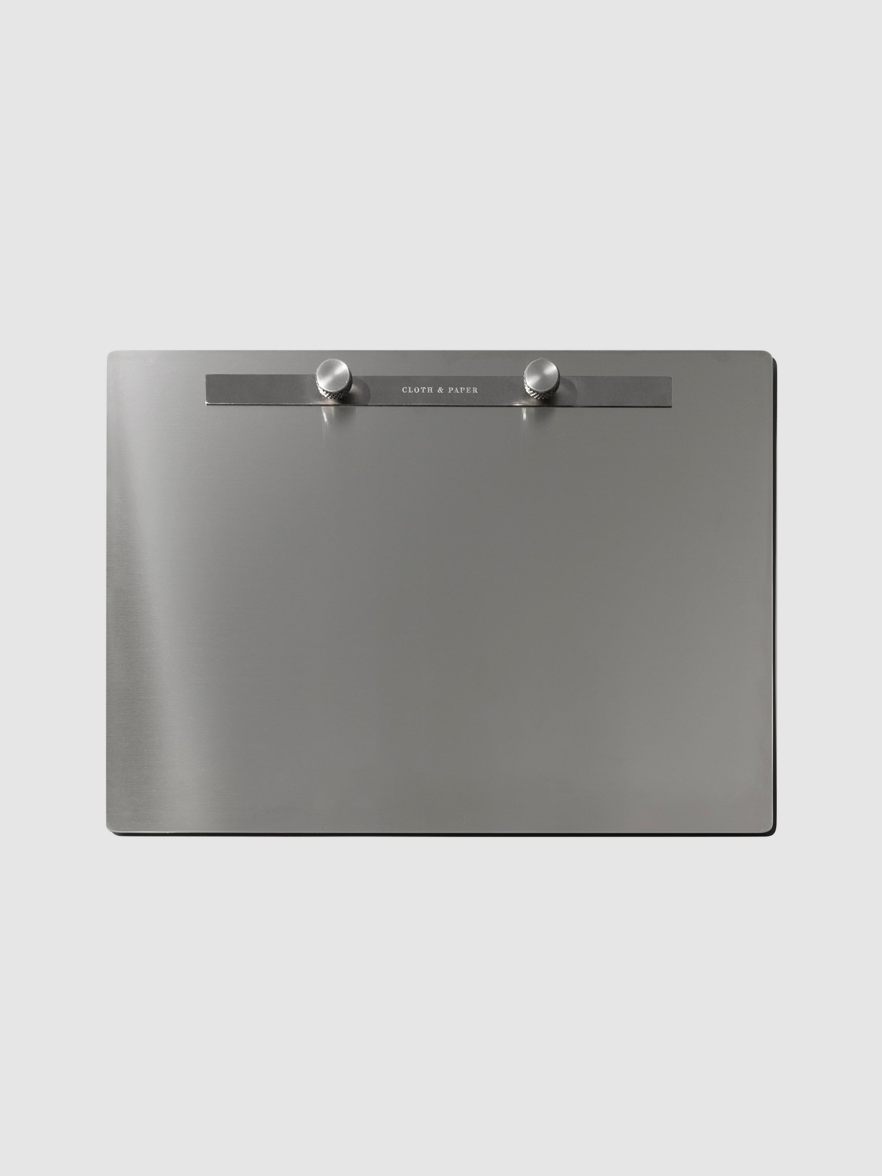 Modern Bound Notepad board, which is stainless steel metal, resting on a neutral background without any inserts