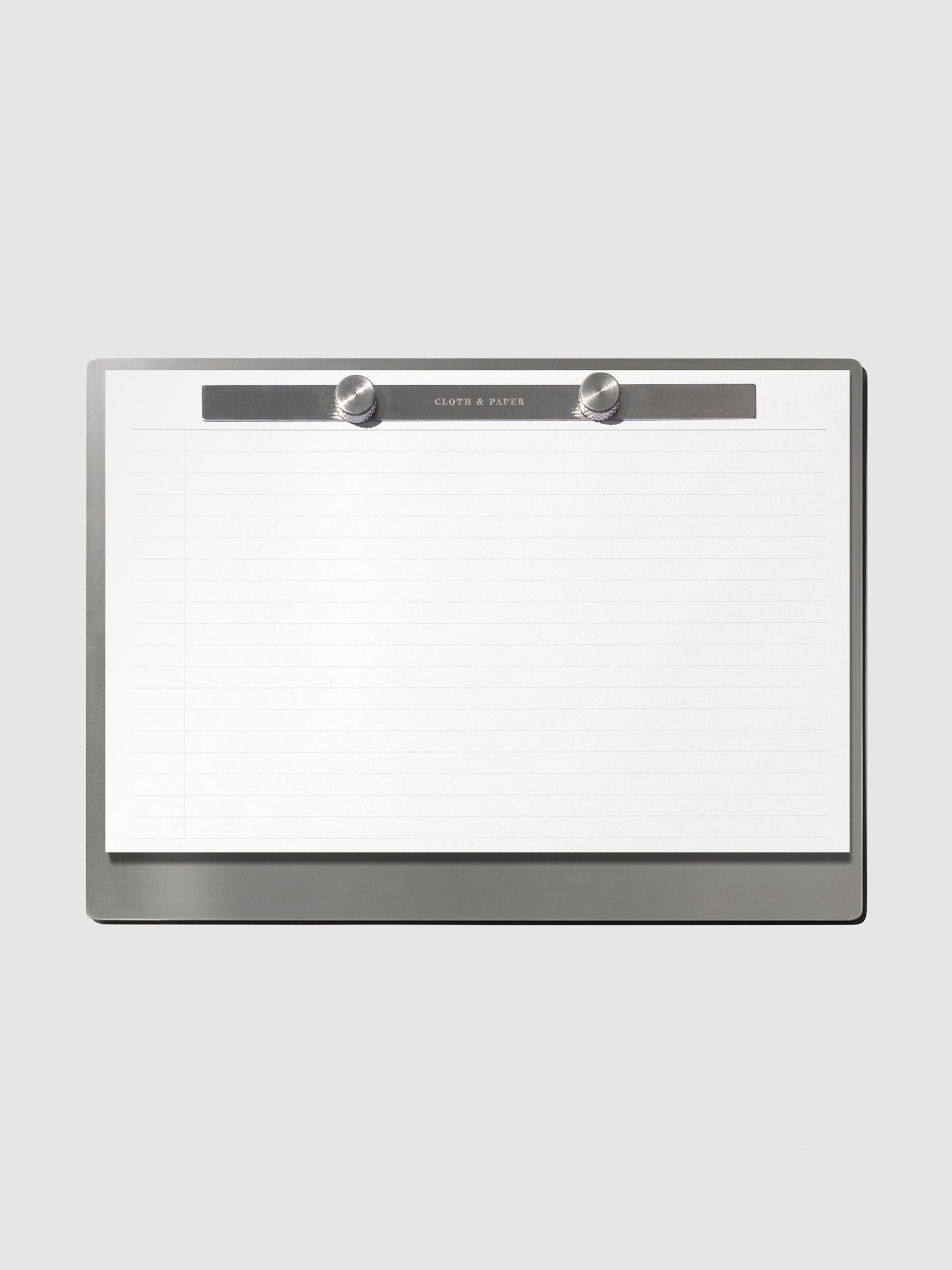 Modern Bound Notepad Insert Refills, lined, filled on the Modern Bound Notepad board, resting on a light gray background