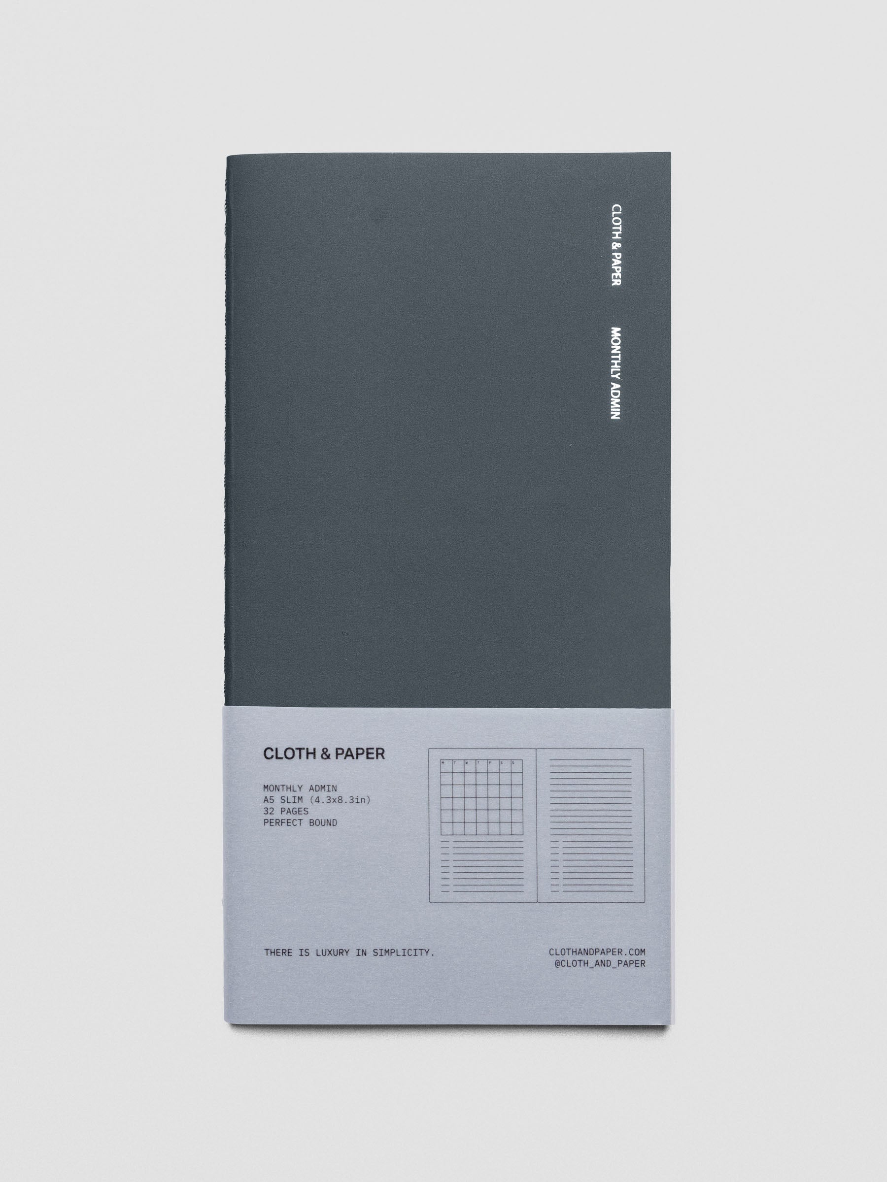 Travel Notebook in size A5 Slim in color Lagoon with Monthly Admin pages shown from the front with packaging belly band.