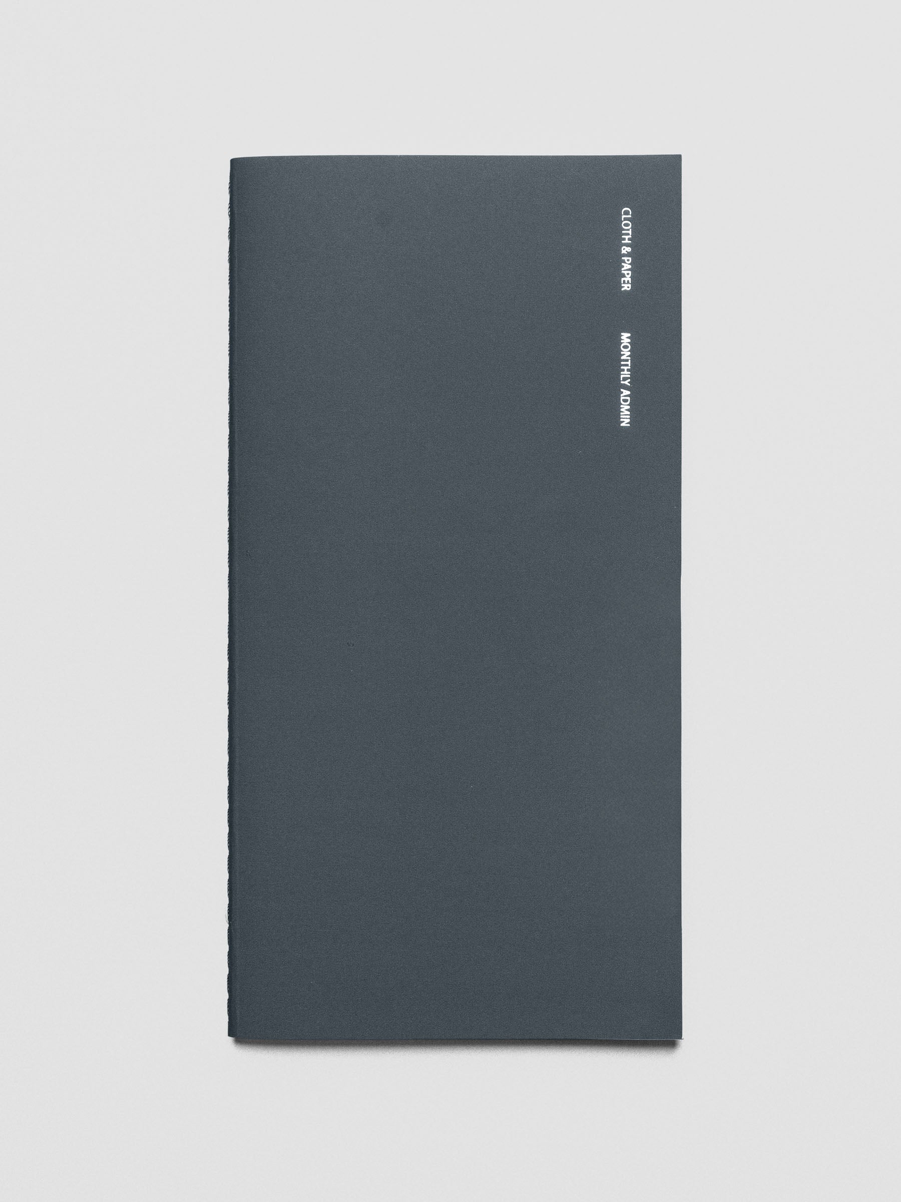 Travel Notebook in size A5 Slim in color Lagoon with Monthly Admin pages shown from the front as a close up.