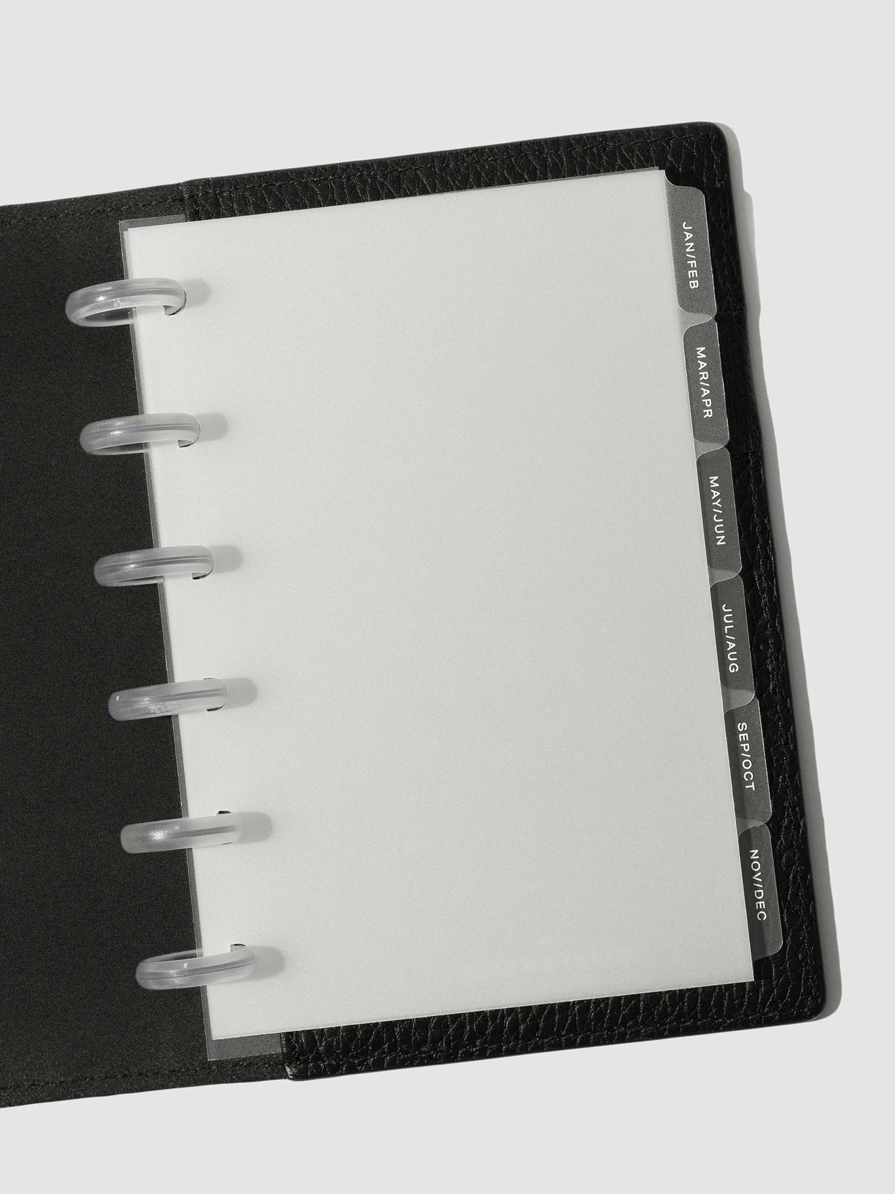 White foil tabs displayed in use inside a black leather folio.