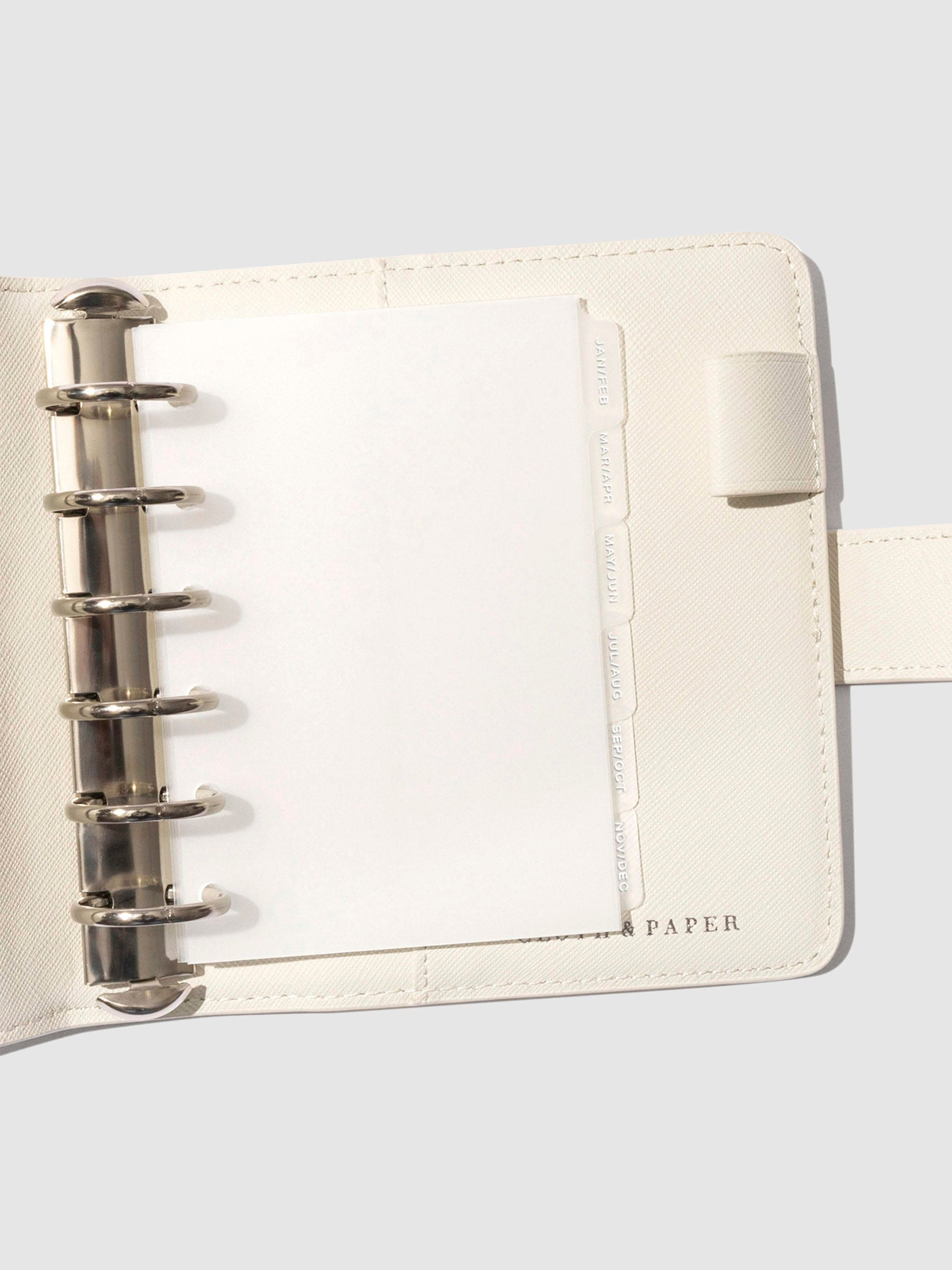 White foil tabs displayed in use inside a leather folio.