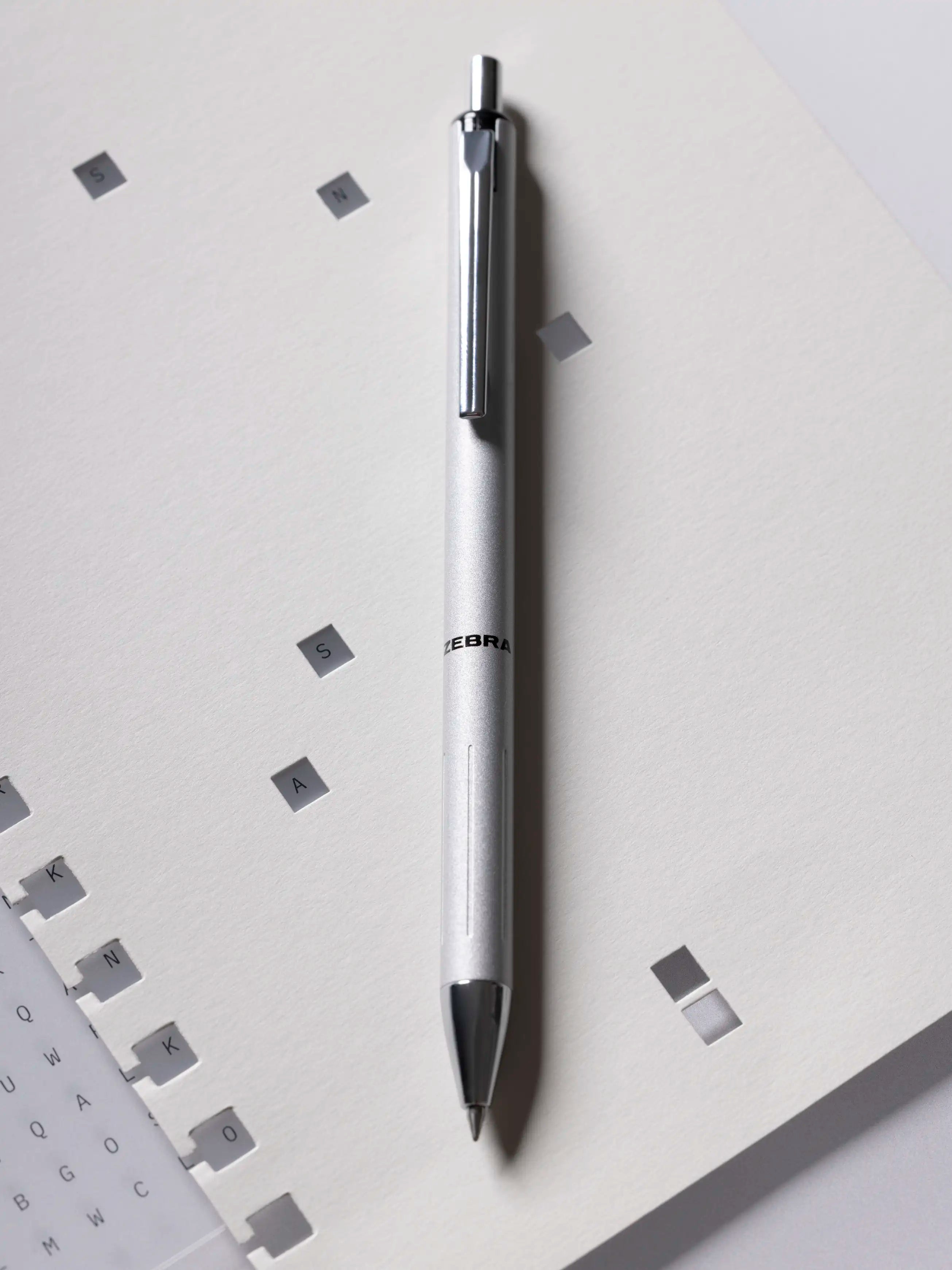 Silver Zebra pen with black accents on a light gray background.